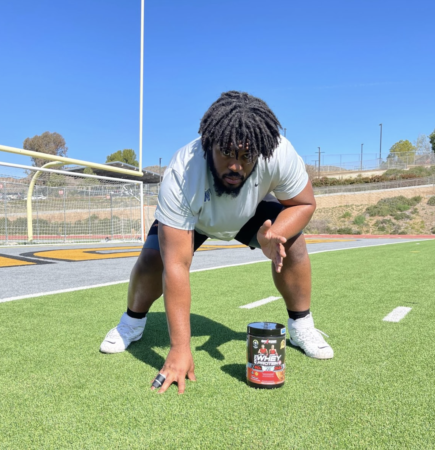 Dylan Parham with a bottle of Six Star Pro Nutrition® 100% Whey Protein Plus