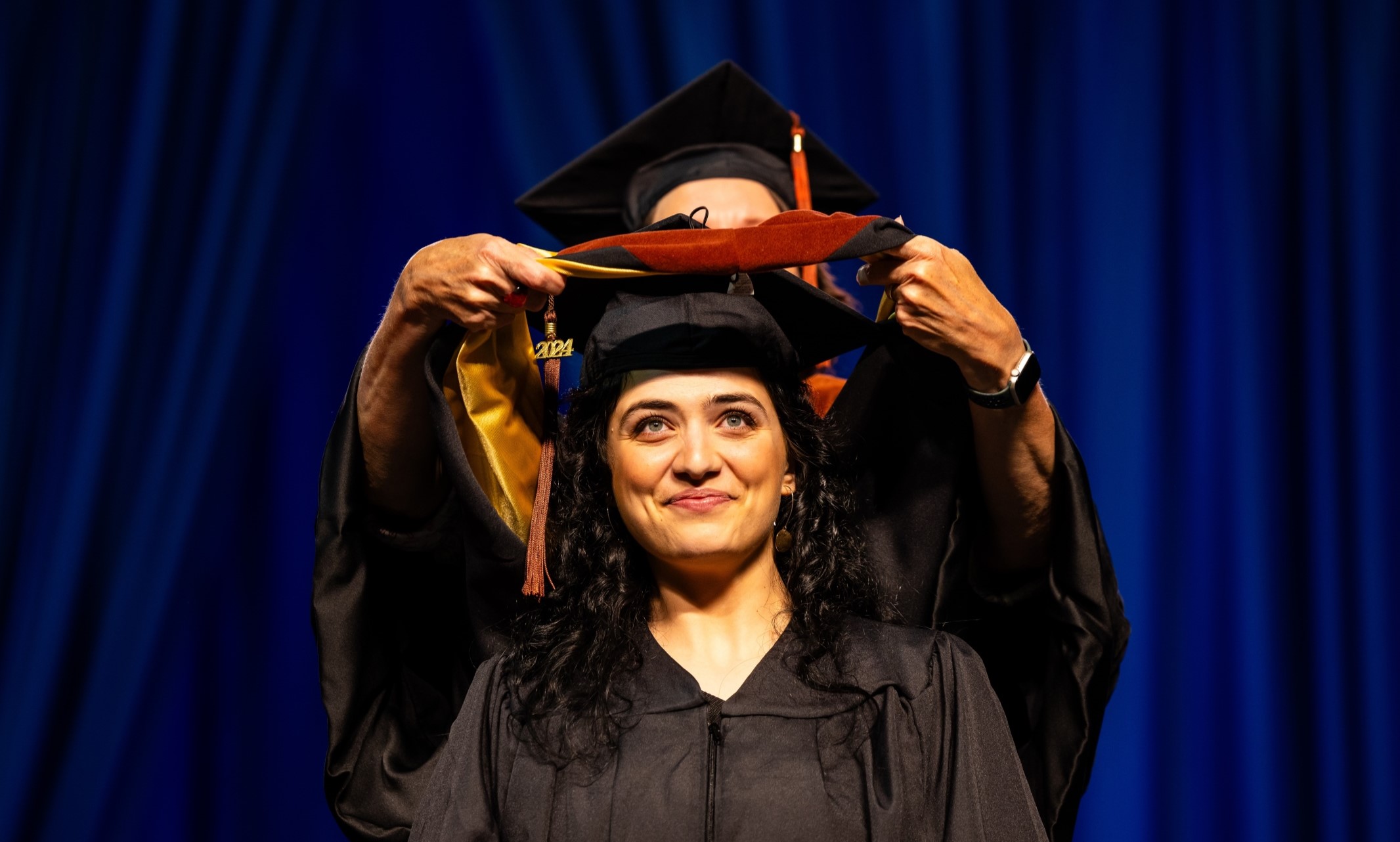 Ph.D. Student Being Hooded During Commencement Ceremony