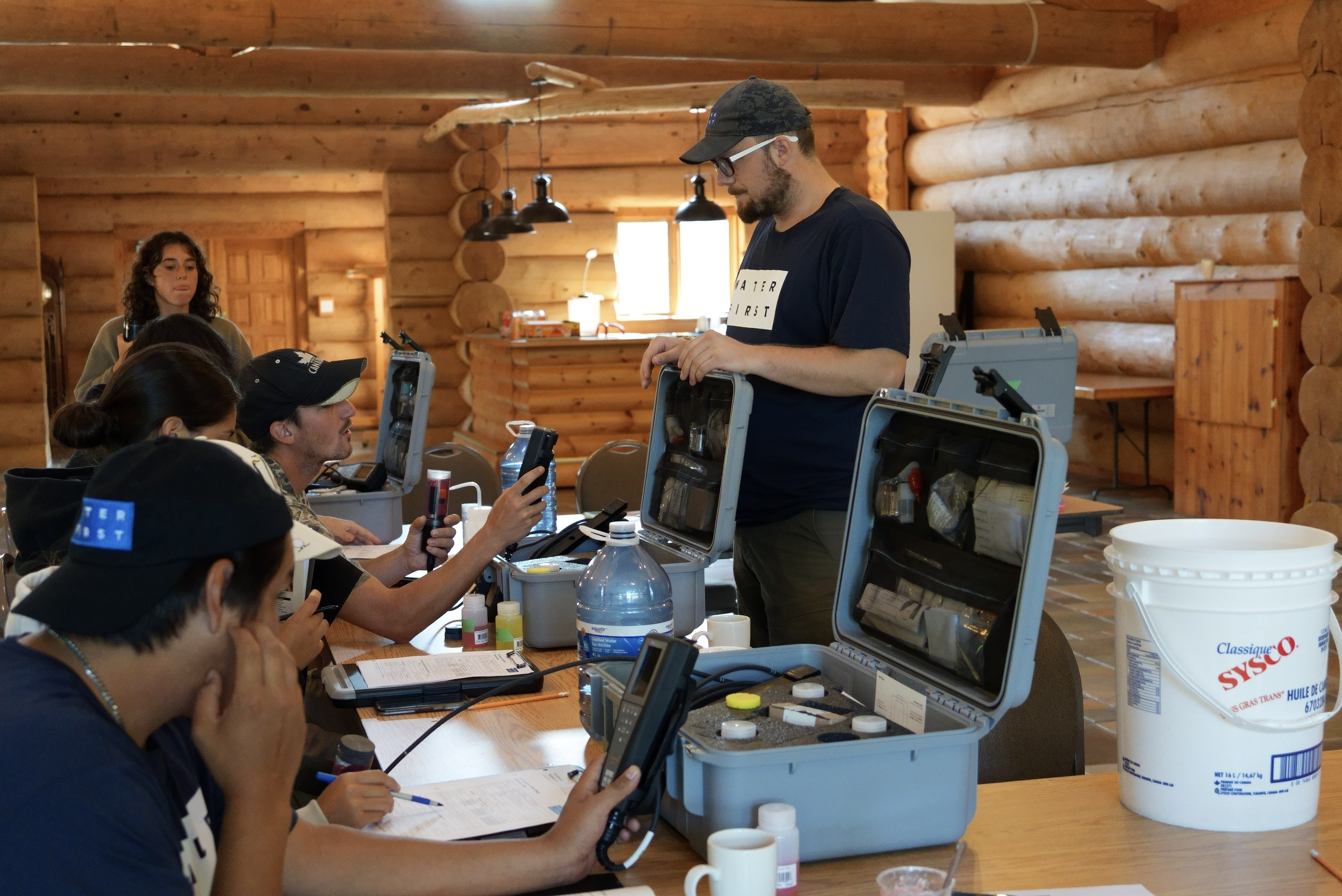 Interns learn to use water quality monitoring equipment under the guidance of Water First trainers