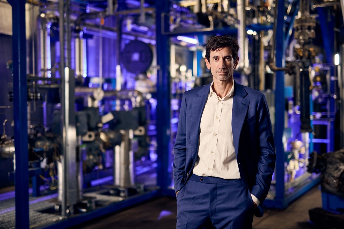 Aether’s CEO Conor Madigan in front of a section of a 100 gallon-per-day (gpd) scale test production facility built by strategic partner GTI Energy at their Chicago-area campus.