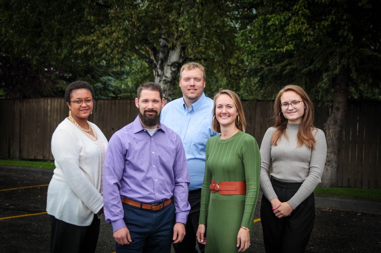 Matthew Blattmachr poses for a photo with fellow University of Alaska alumni from the Peak Trust Company team outside the company’s midtown offices.