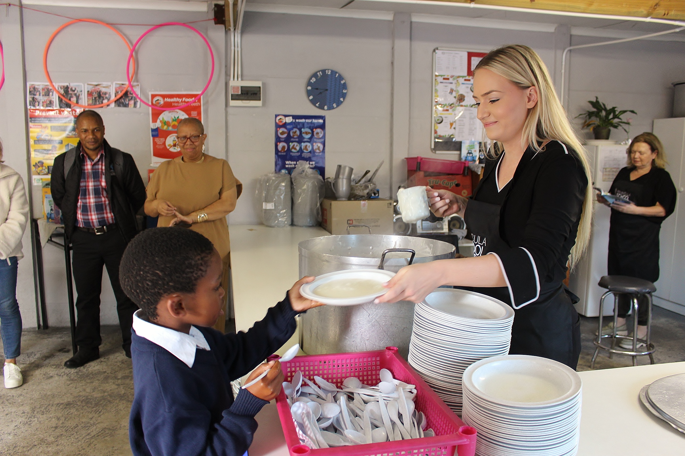 Ferrellgas employee serves food to a school student in South Africa.