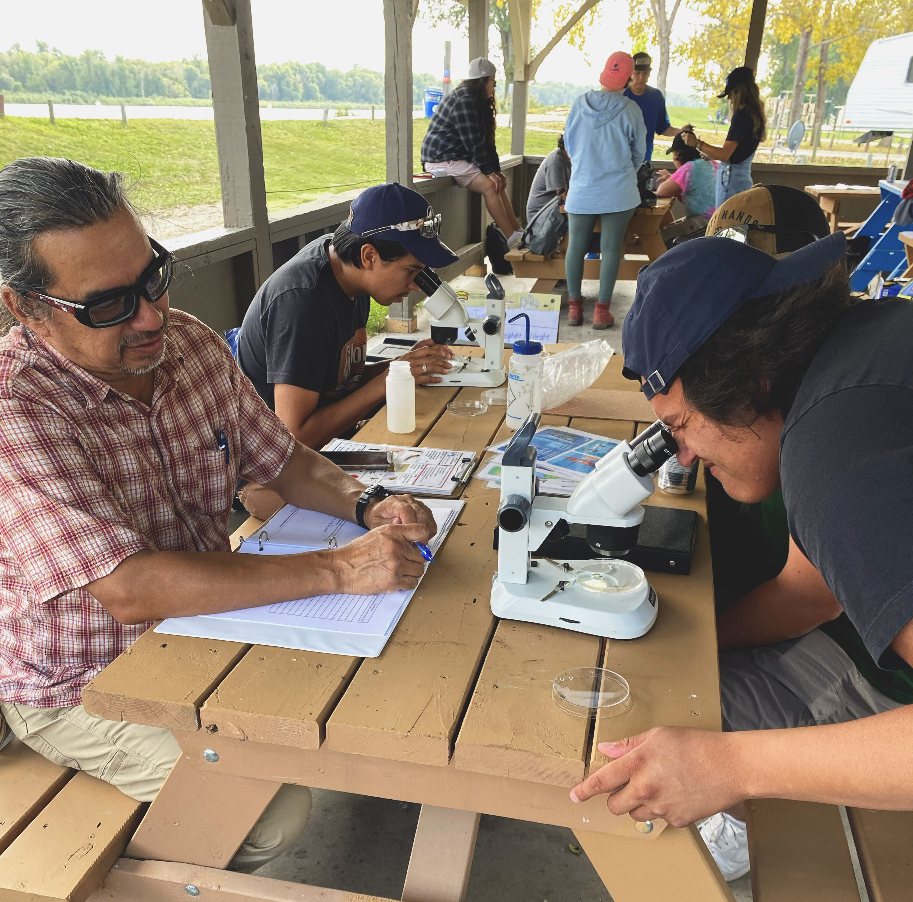 Water First interns examine water samples under a microscope during workshop