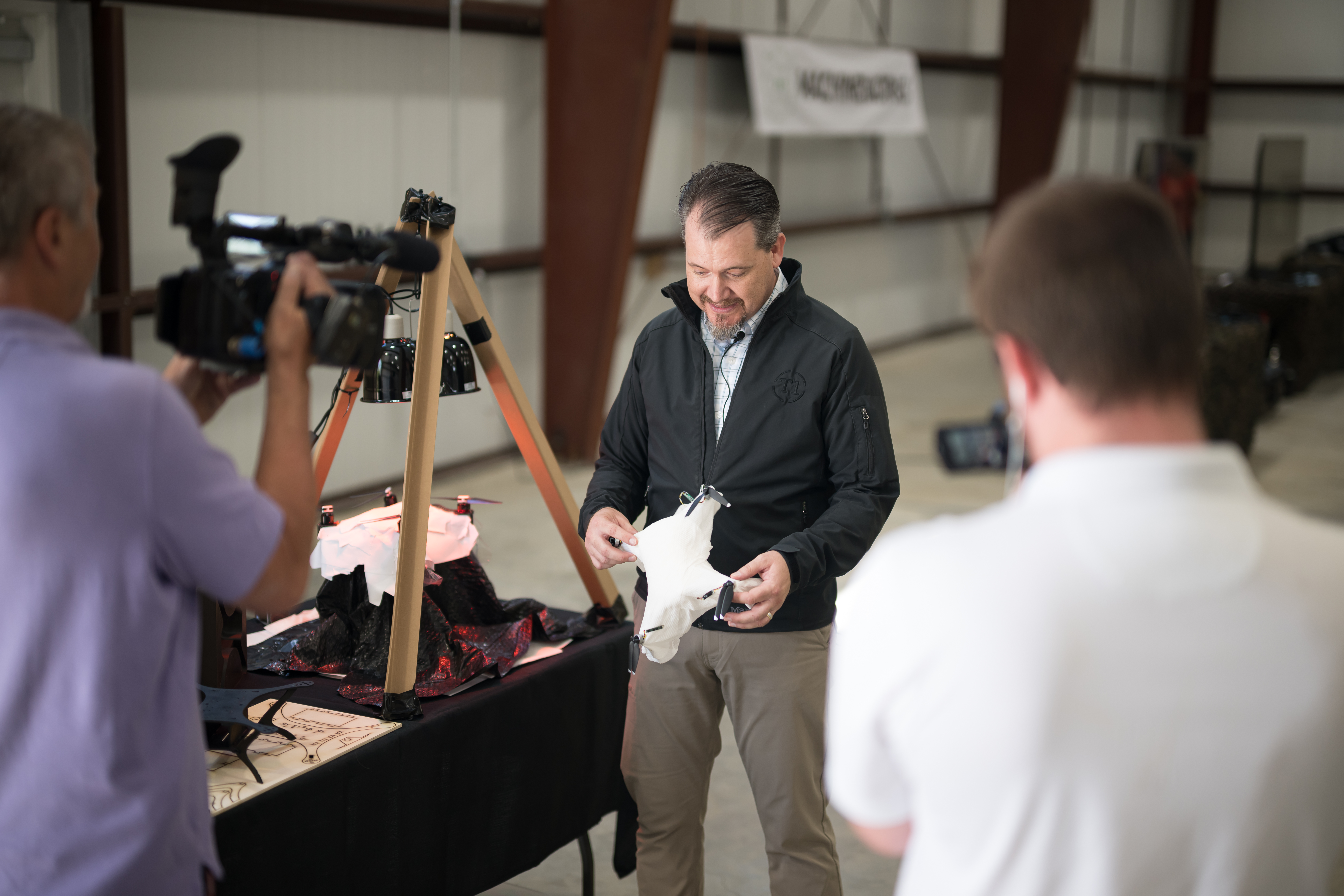 TurbineOne CTO Matt Amacker demonstrates drone technology during the opening of T1 MachineWorks in Old Town, Maine, on Aug. 27, 2026. The new operation expands TurbineOne’s capacity to develop and test technologies for frontline defense missions.