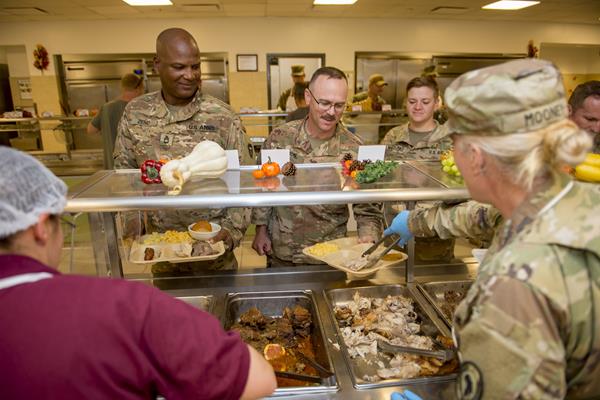 Service members at the Combined Joint Task Force-Horn of Africa at Camp Lemonnier, Djibouti, receive their Thanksgiving meal at the Dorie Miller galley Nov. 22, 2018. Customer support teams at DLA Troop Support Europe & Africa helped ensure service members throughout the region had a taste of home for the holidays by providing Thanksgiving meal items.  