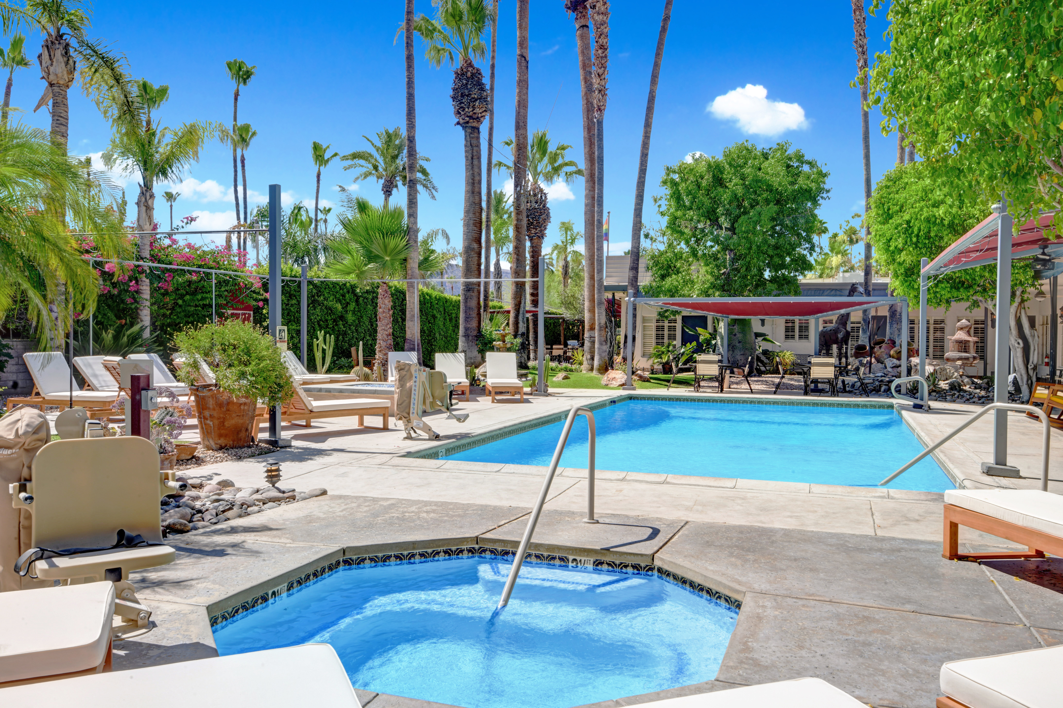 The pool and spa at the clothing-optional Desert Paradise Resort in Palm Springs await gay men who are ready for a change of scenery this summer.