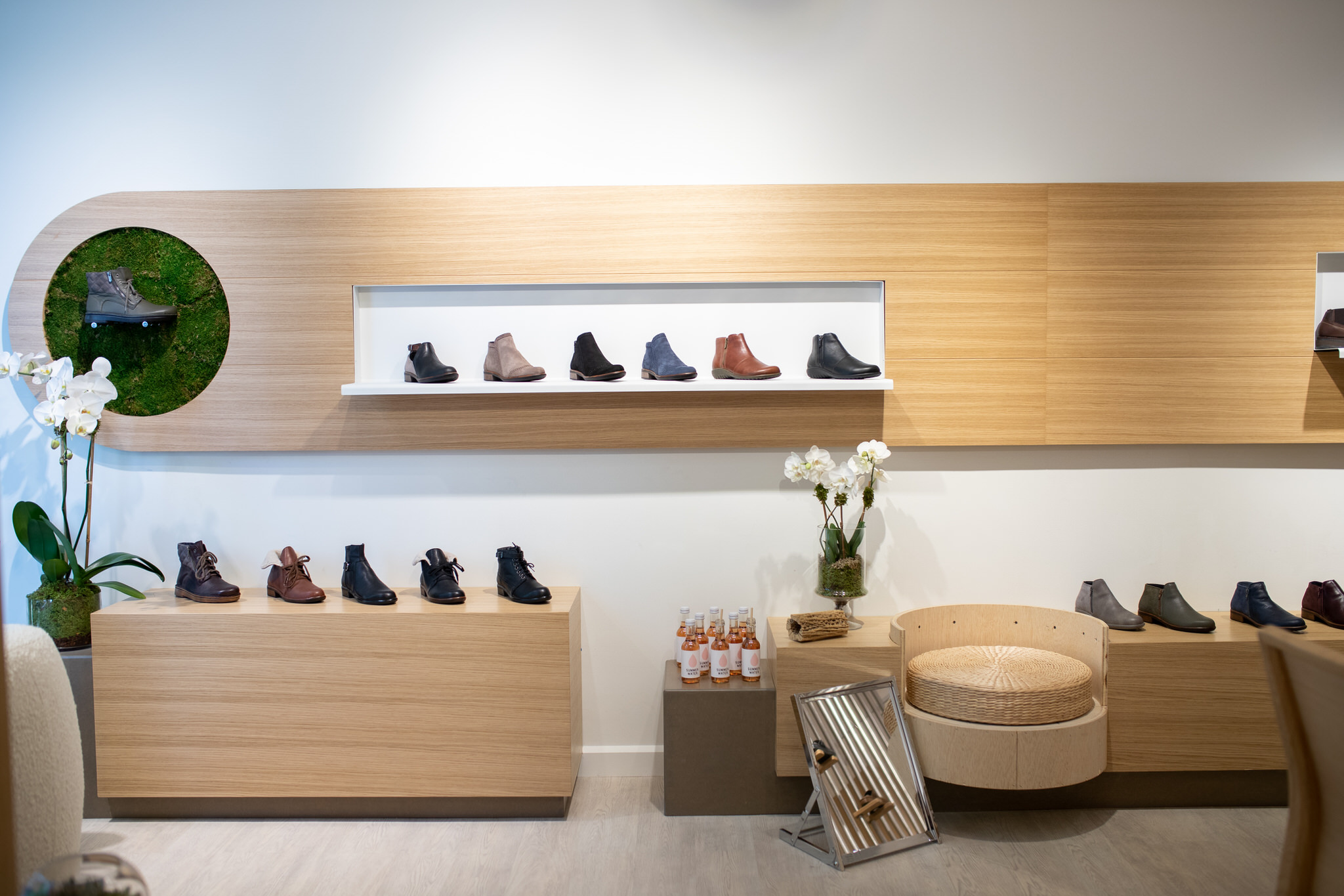 Image shows shoes and boots beautifully displayed on floating store shelves