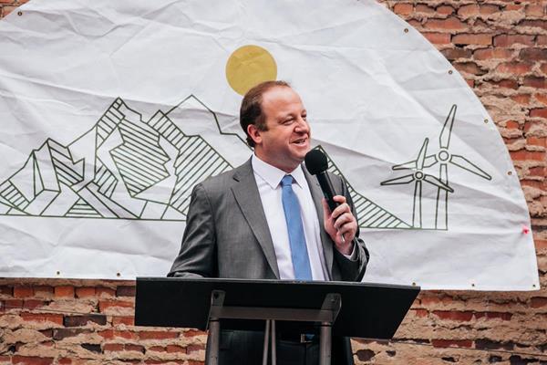 Governor Polis at another event hosted by The Alliance Center