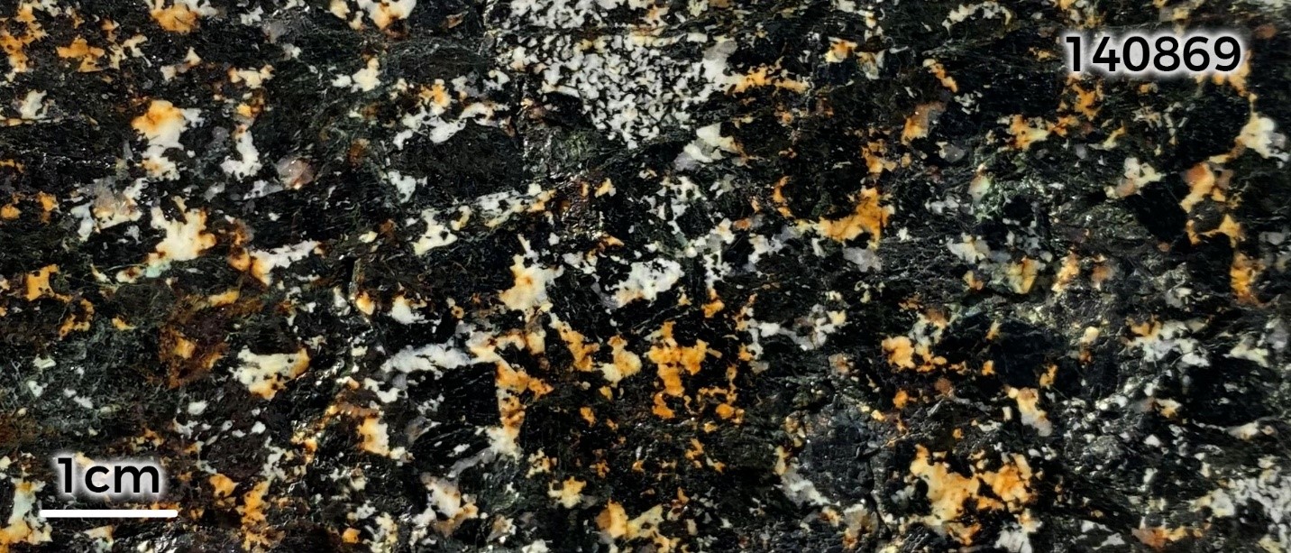 Sample 140869: Coarse-grained, malachite-azurite-stained hornblende gabbro. The sample returned an assay of 0.76% Cu.