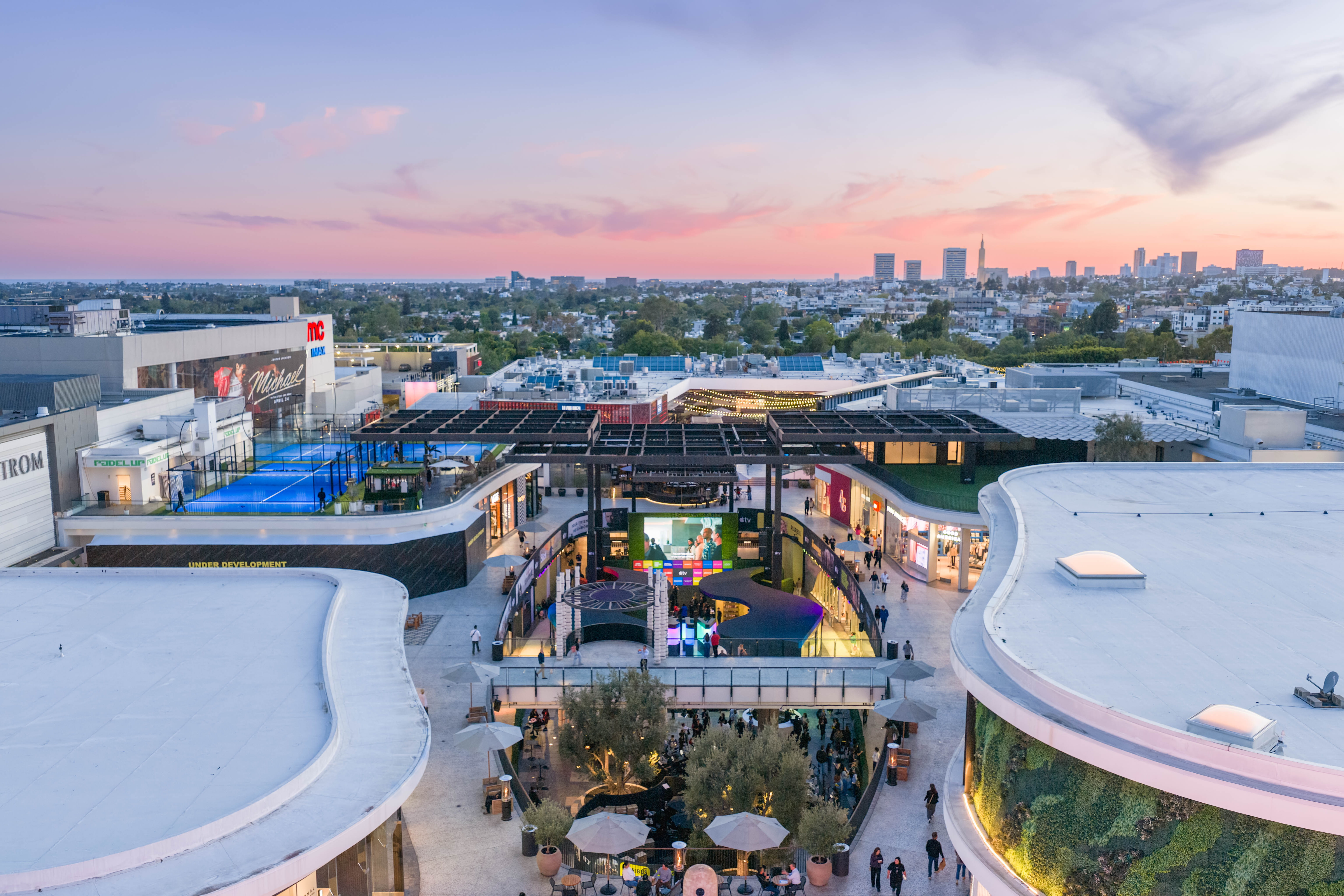 Aerial view of Westfield Century City at dusk with visible activations in the central plaza and city skyline in the distance.