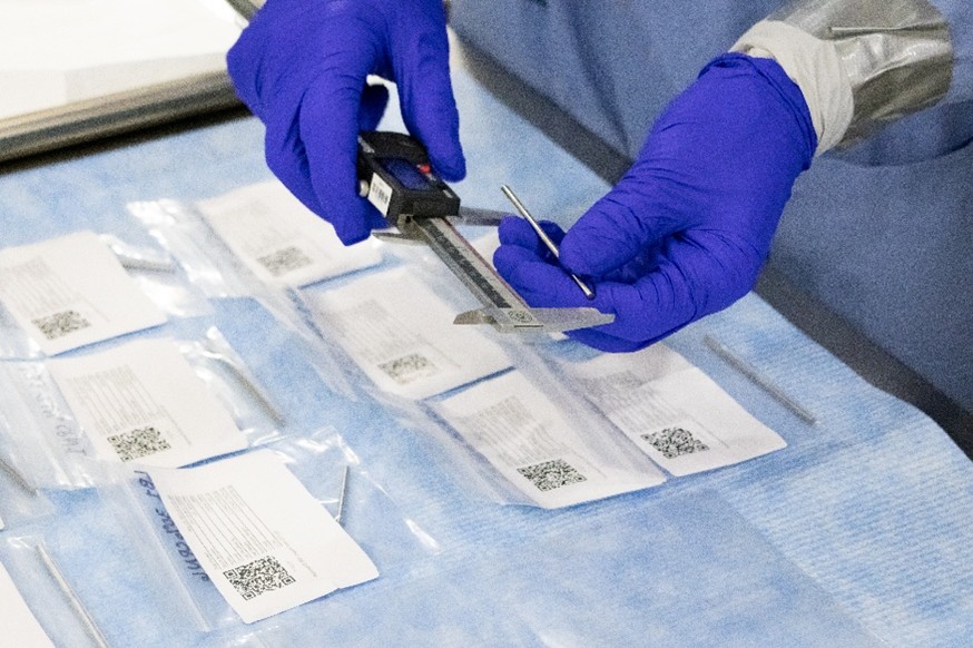 Taking dimensional measurements of a finished enriched uranium-zirconium coupon sample