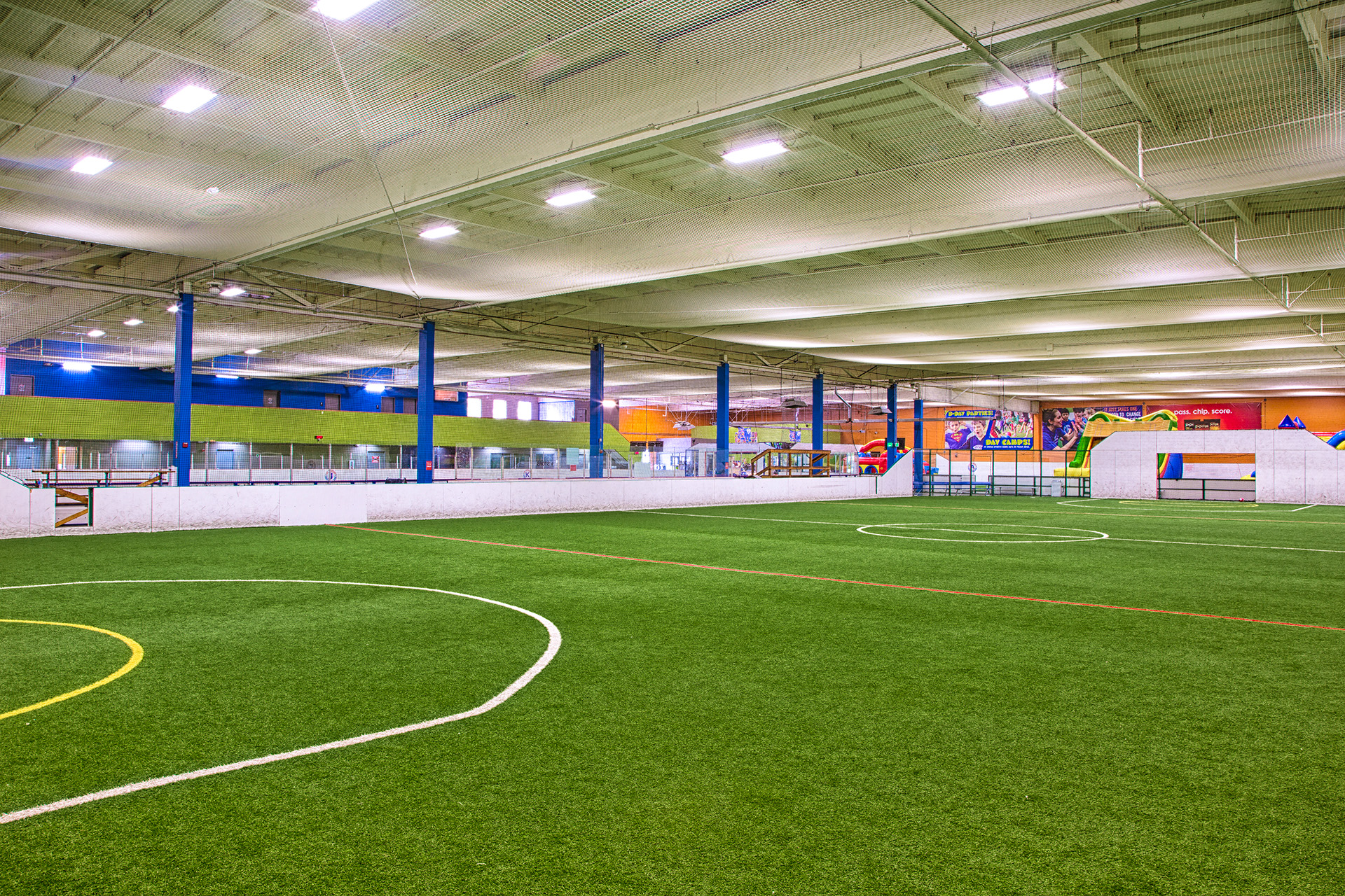 Large indoor soccer field with green turf at Arena Sports in Seattle just acquired by Bay Club.