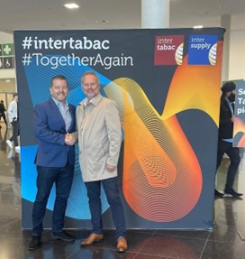 TAAT® Chief Executive Officer Michael Saxon (left) is pictured with GGE Chief Executive Officer John Hilton (right) at the InterTabac trade show in Dortmund, Germany. Mr. Saxon and Mr. Hilton are currently aligning the resources of TAAT® and GGE to optimize growth-stage commercialization of TAAT® products in the United Kingdom as GGE prepares to receive its largest shipment to date from the Company.
