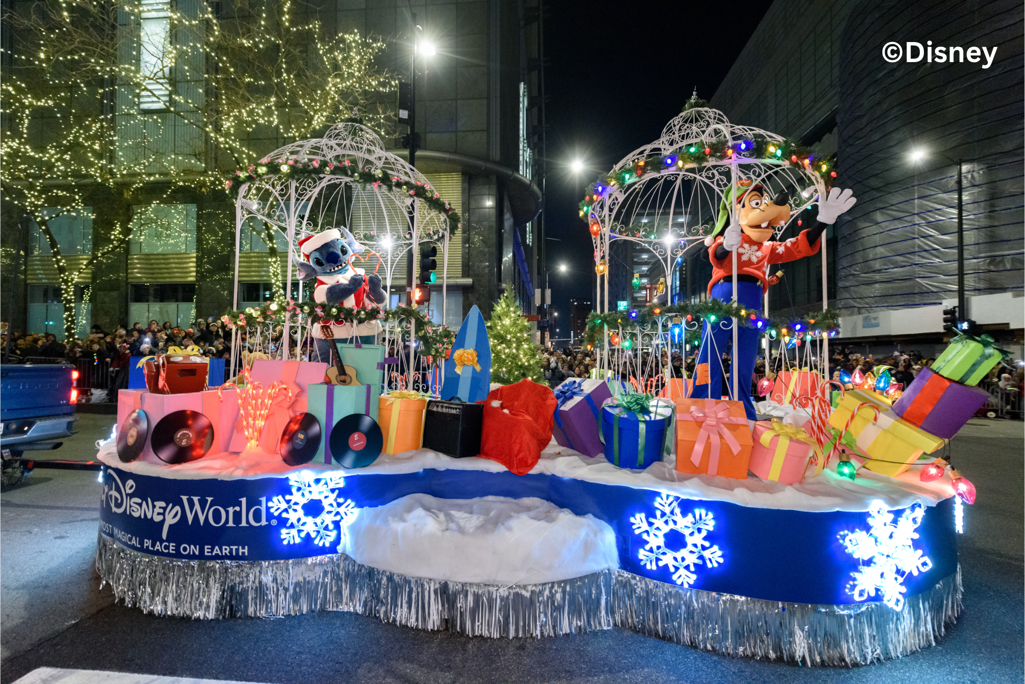 Stitch Dressed as Santa and Goofy from Walt Disney World® Resort bring the magic to The Wintrust Magnificent Mile Lights Festival®.