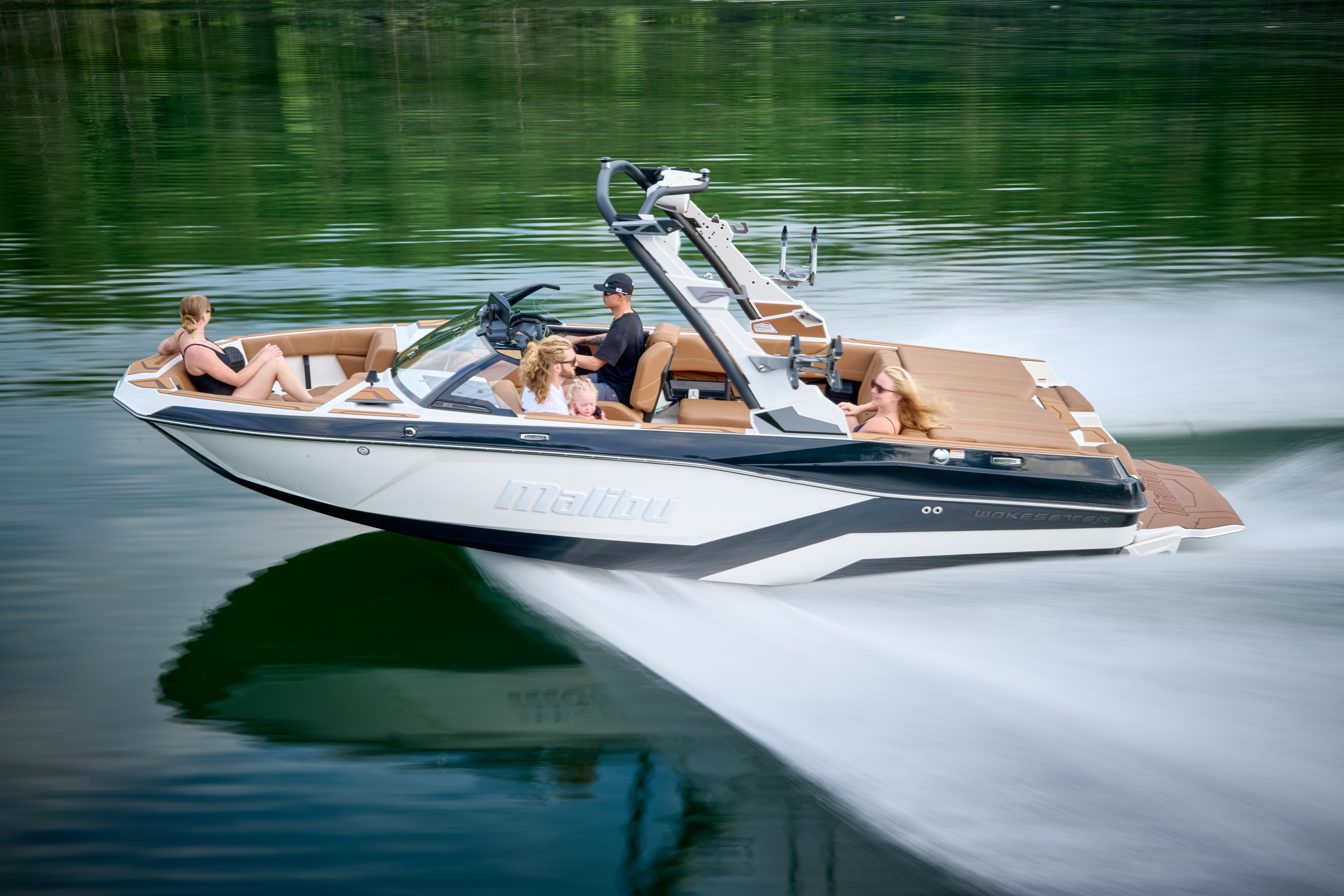 Designed for active watersports families, the Malibu Wakesetter 21 LX delivers premium performance, comfort, and versatility in a compact, tow-friendly package—shown here cruising with room for the whole crew.