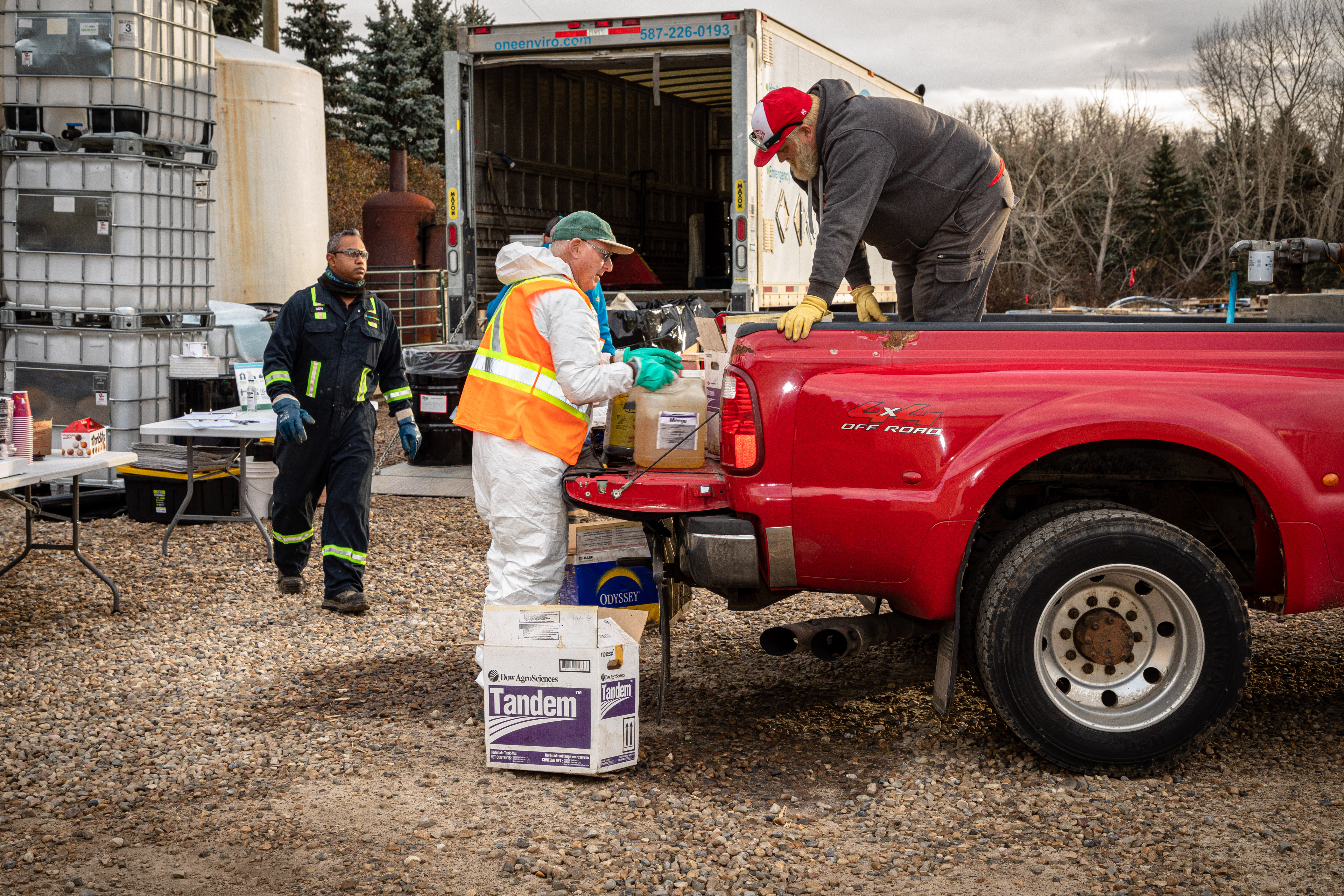 Unwanted pesticides and old livestock medications being dropped off and sorted at a collection site for safe disposal.