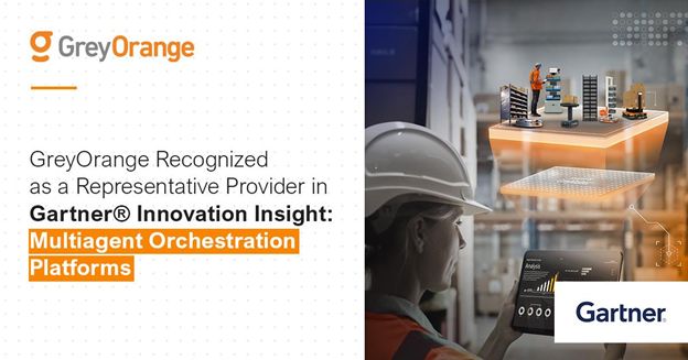 Woman wearing hard hat in warehouse setting uses tablet to interact with GreyMatter multiagent orchestration platform