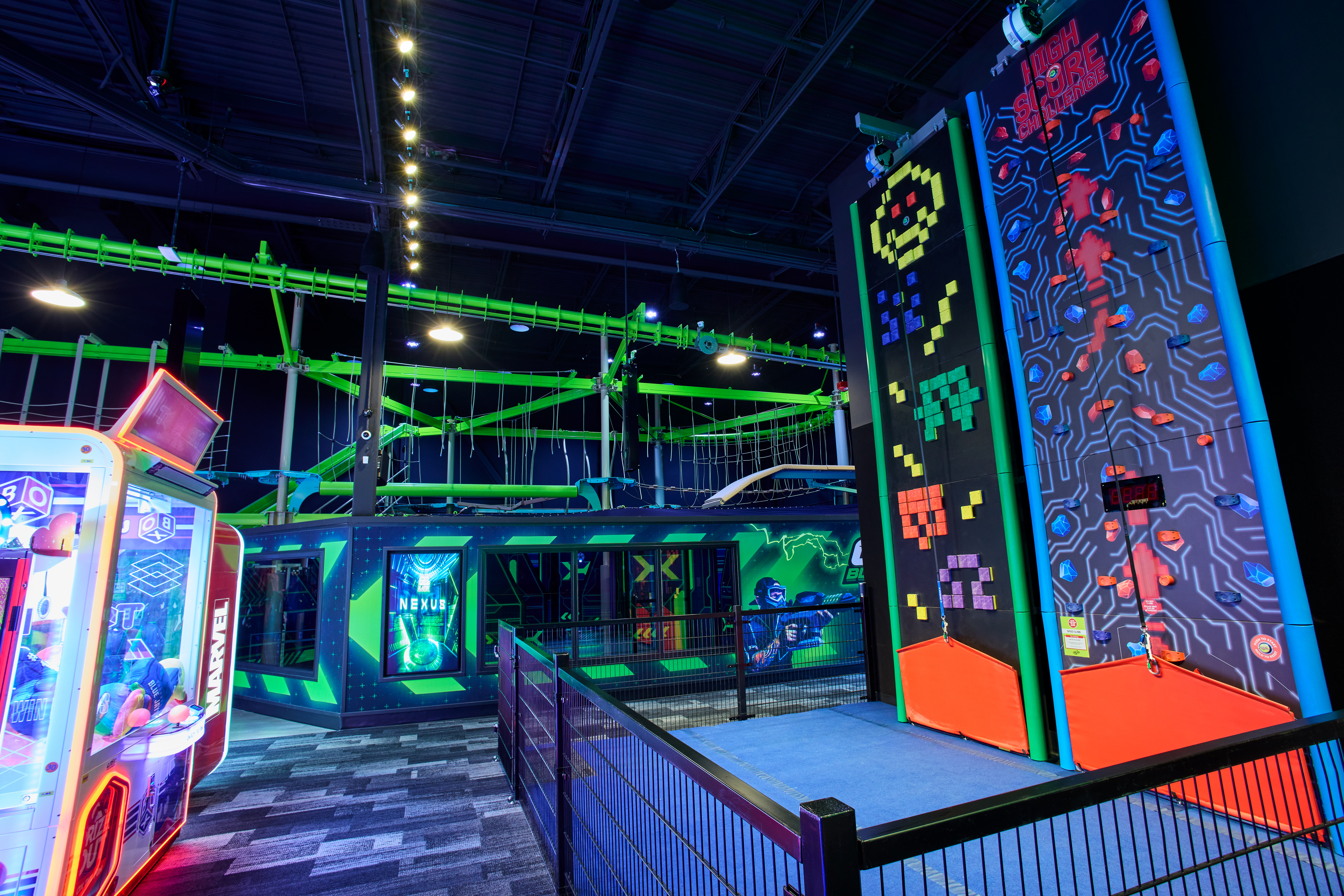 Climbing wall with Gel Blasters course in the background