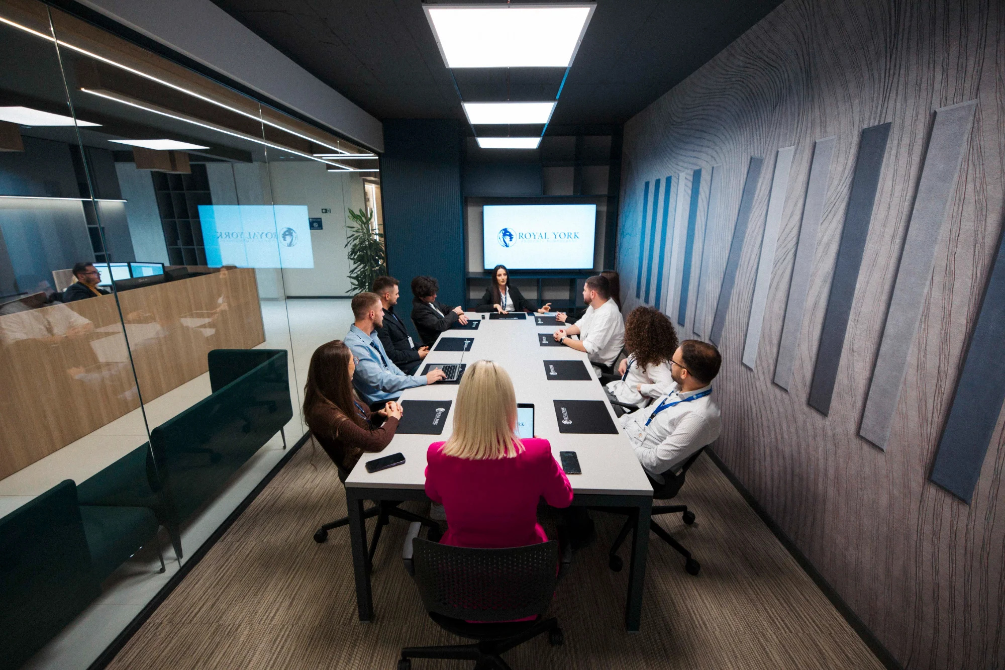 Royal York Property Management leadership team meeting in corporate boardroom with company logo displayed