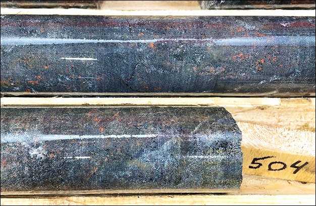 Photograph of core at 504 m at the end of drill hole HK22-013, with 2m @ 2.84% TREO and 1.1 g/t gold. Shown is the complete replacement of host rock by apatite-biotite-magnetite alteration. Gold assays are strongly correlated with monazite geochemistry in the bottom 11 metres of the hole, indicating a gold - and REE-rich hydrothermal fluid phase.