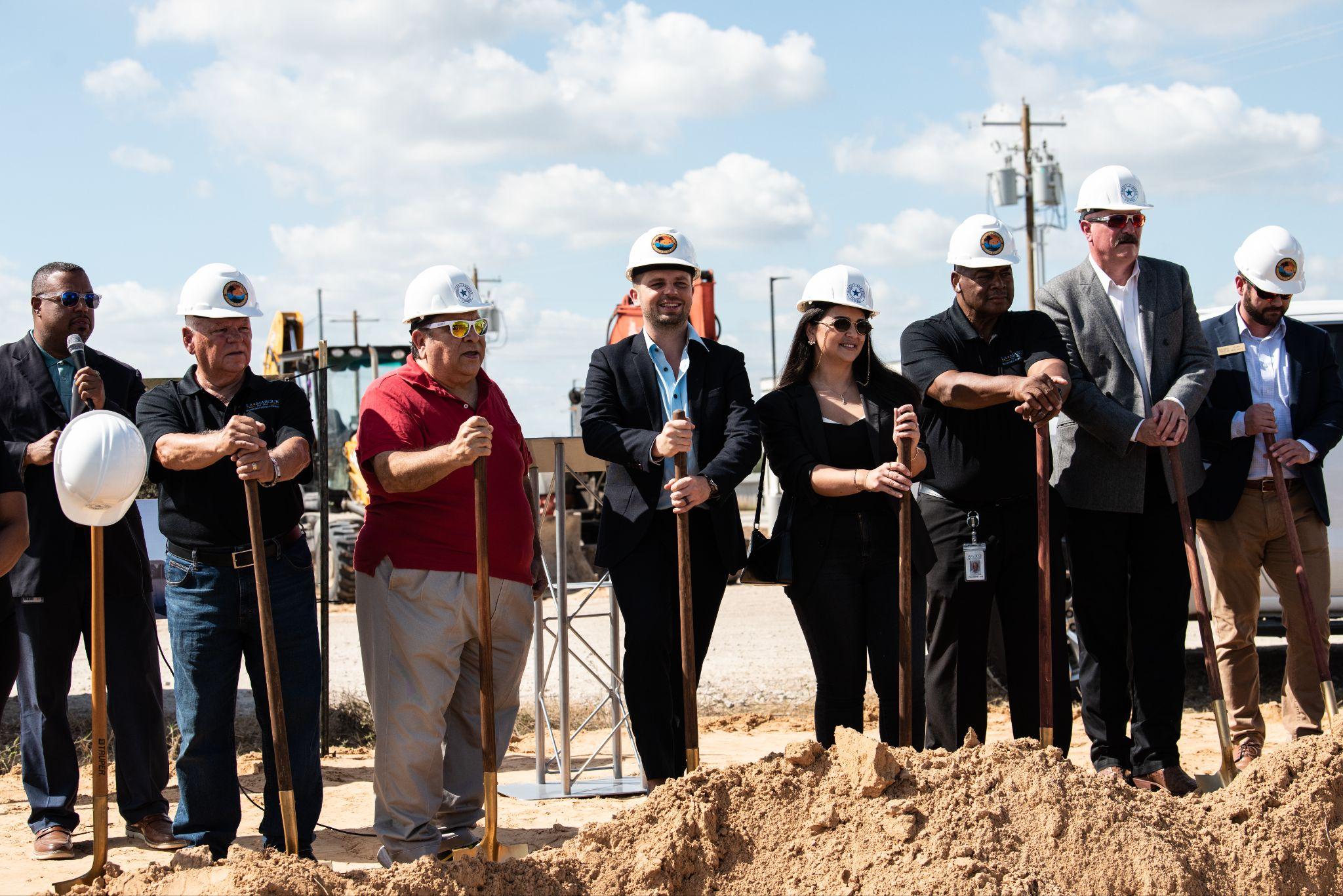 Members of the Dataprana team pose for a pre-groundbreaking photo with Texas City-La Marque administrators.