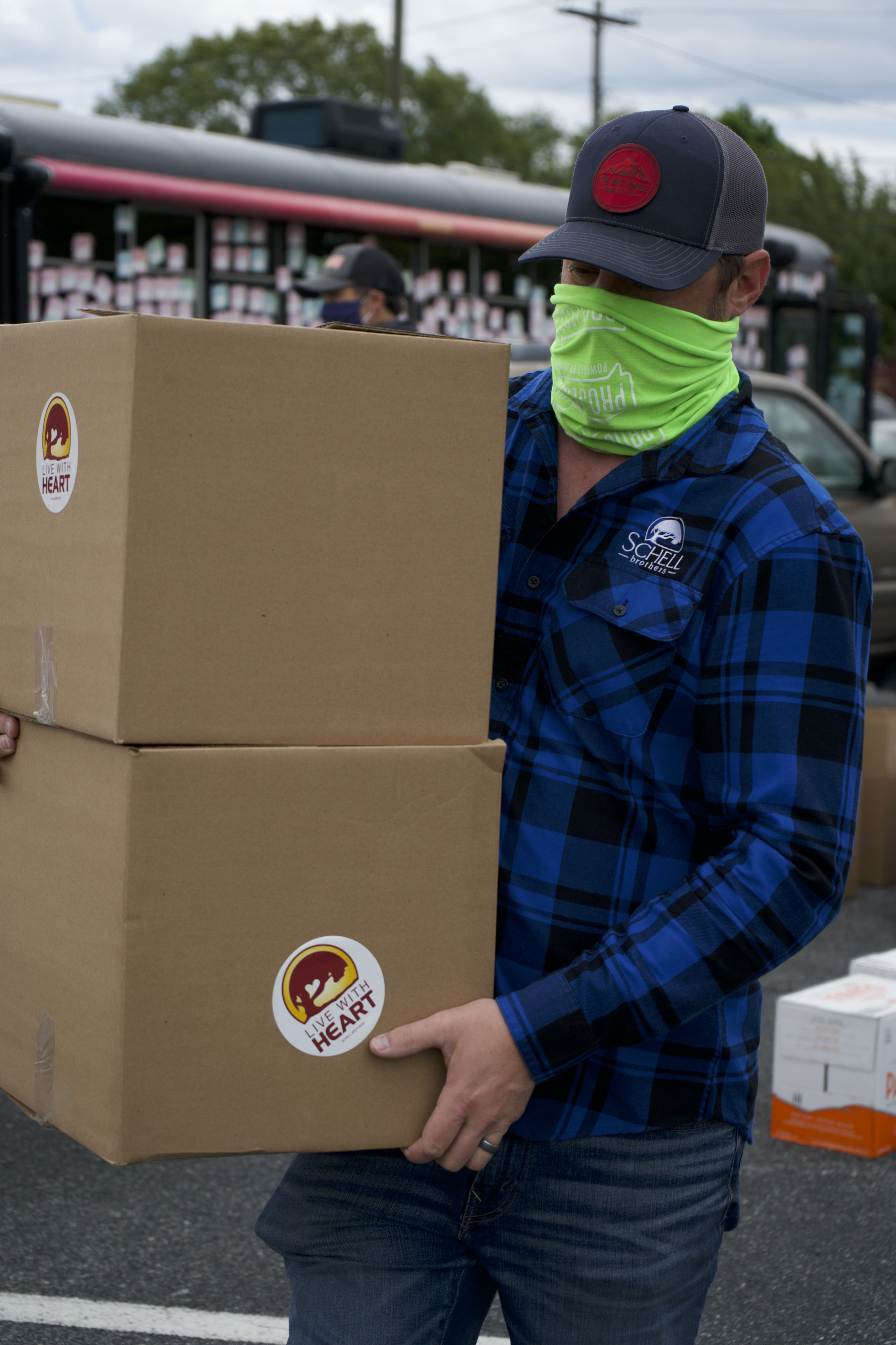 Schell team member distributing food boxes to families in need. 