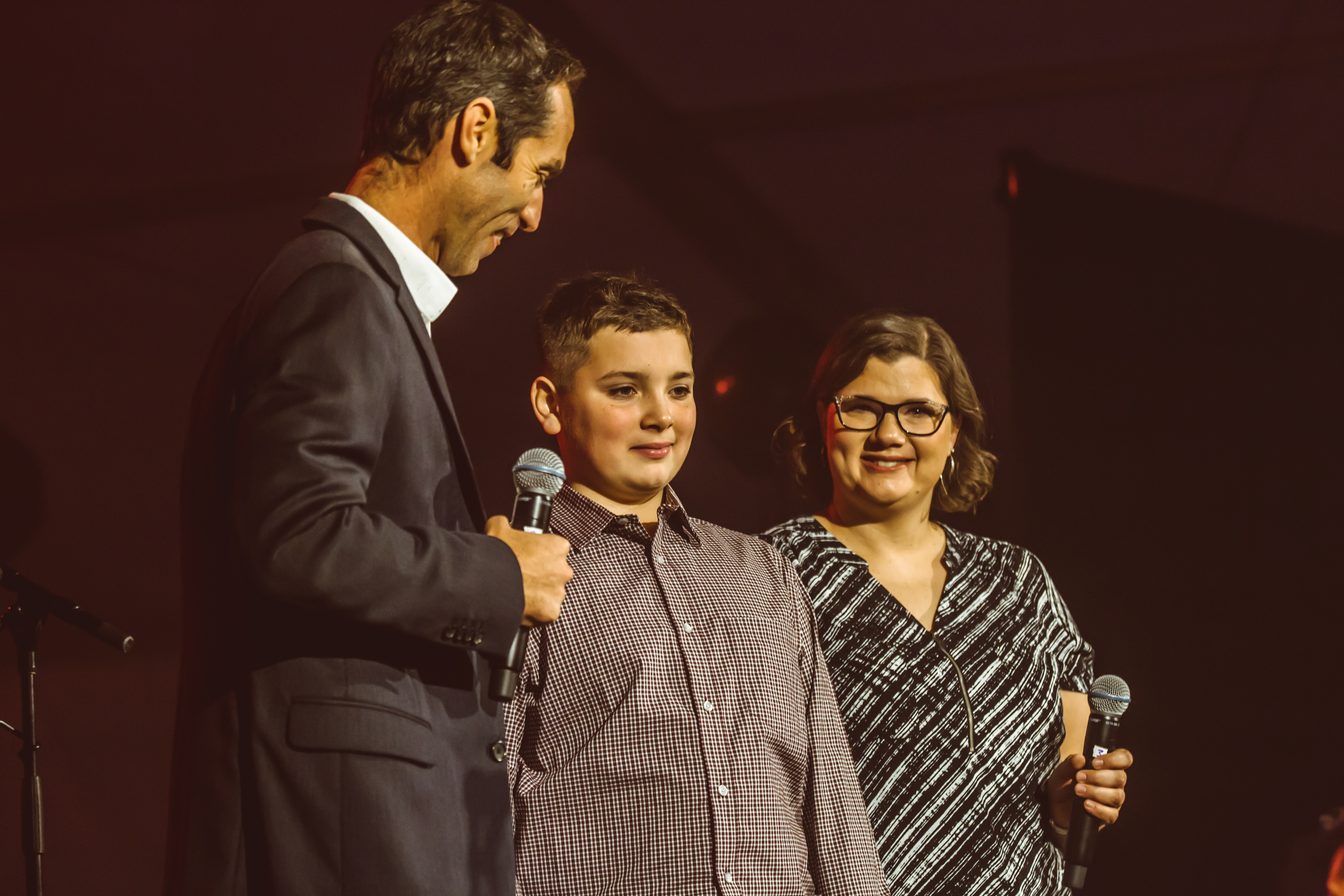 Summer camp alum Ben R. and his mother join Camp Director Scott Hicok on stage to share their Camp Southern Ground experience.