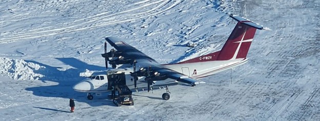 A fixed-wing aircraft (Dash 7) shipping the supplies to the field camp at Ferguson Lake Project