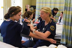 Nursing majors practice patient skills on each other at Georgia College & State University.