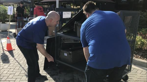 Ultimate Medical Academy President Thomas Rametta (left) helps team members move their desktop workstations and other equipment to as the institution transitions more than 1,500 Tampa Bay area team members to remote work environments to support social distancing and help slow the spread of COVID-19. 