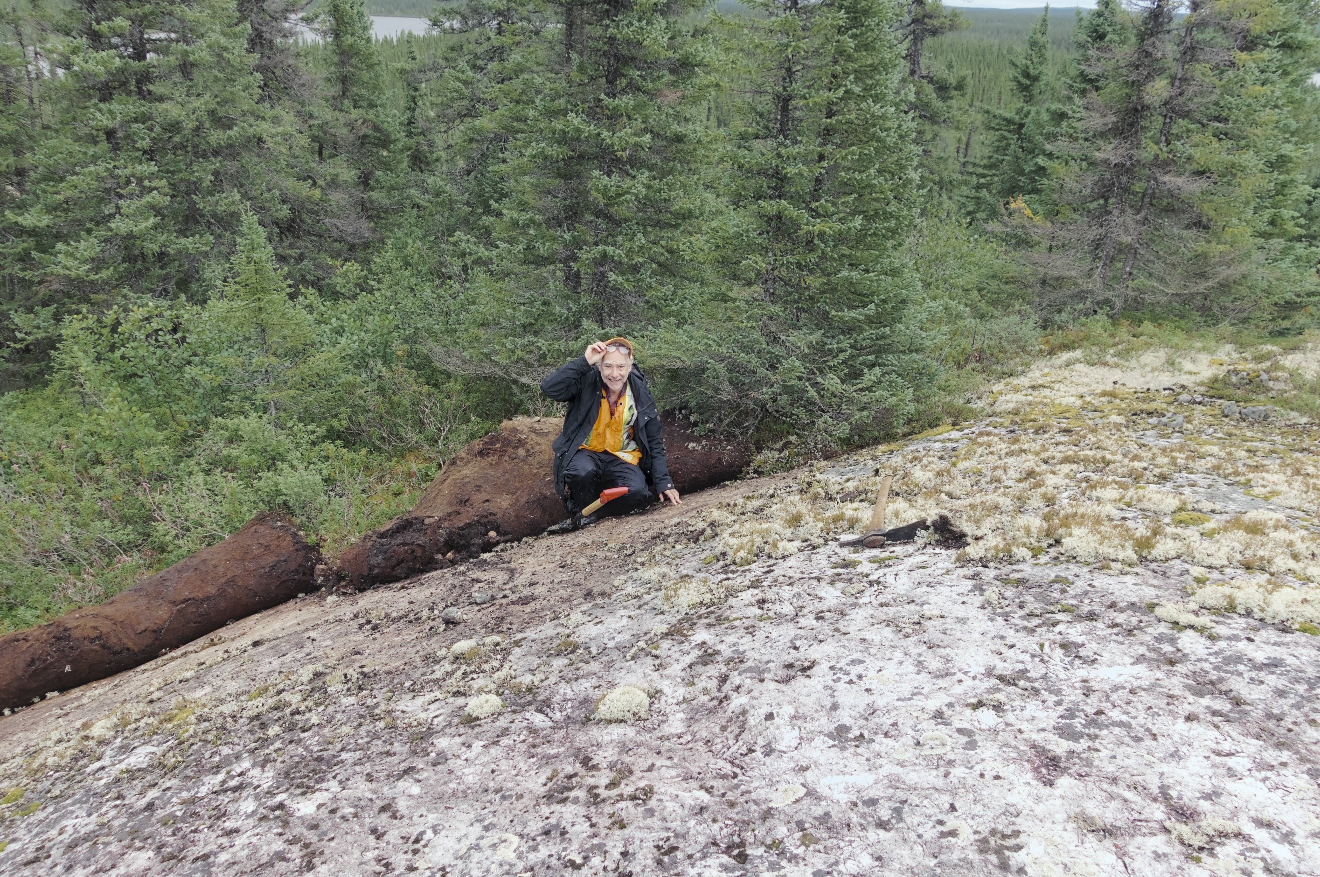 Mr. Rémi Charbonneau, Ph.D., P. Geo., of Inlandsis Consultants, discoverer of the Mirage lithium pegmatite field, examining a spodumene-rich outcrop