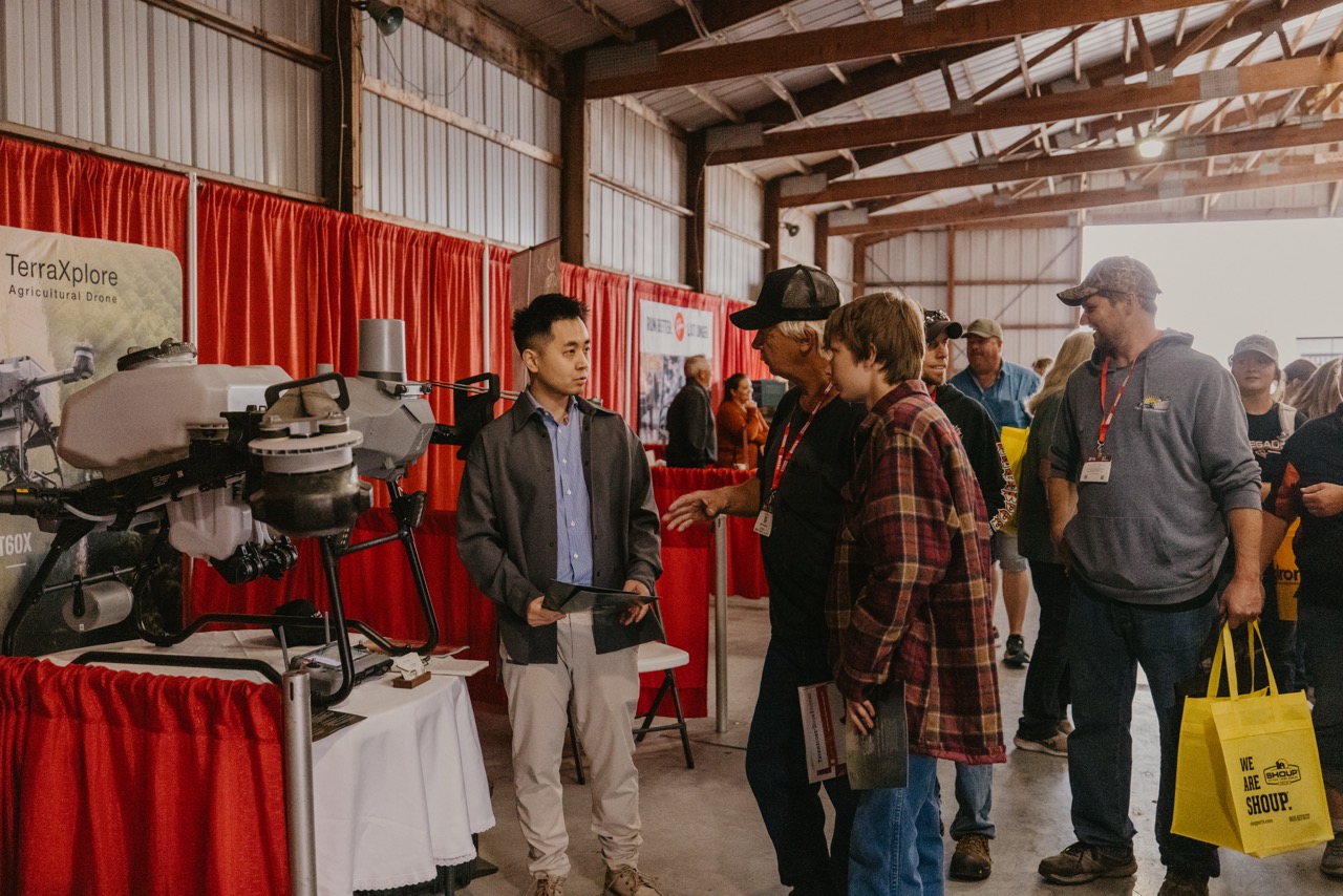 Farmers viewing agricultural drone display at Husker Harvest Days 2025 exhibition in Grand Island, Nebraska
