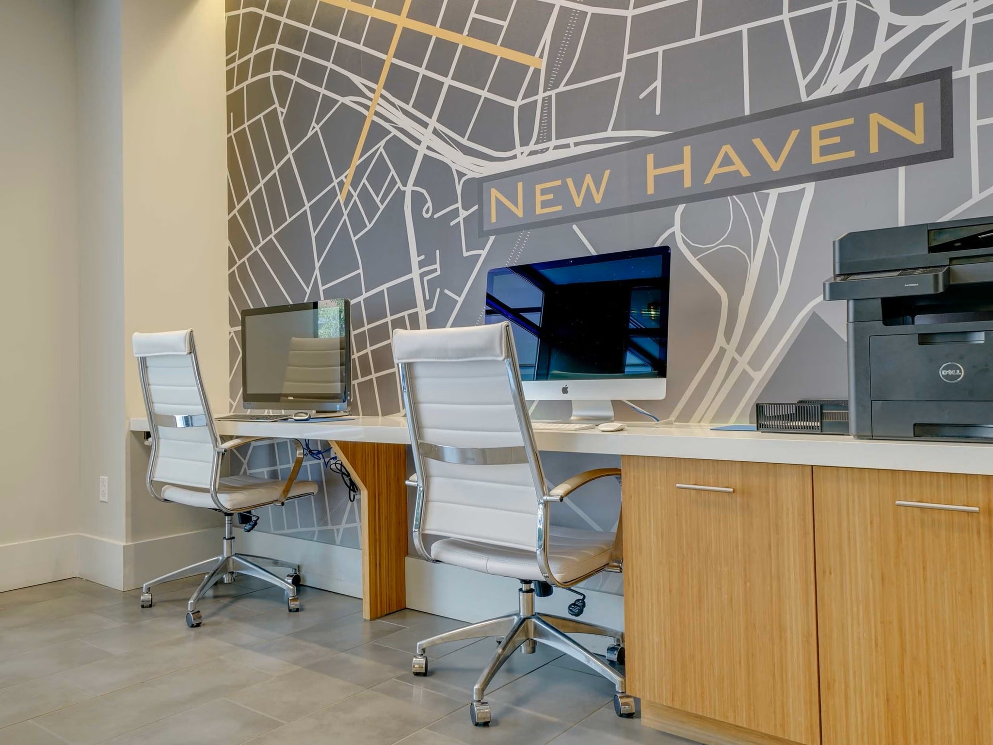 Business center at College & Crown equipped with workstations and high-speed internet access.