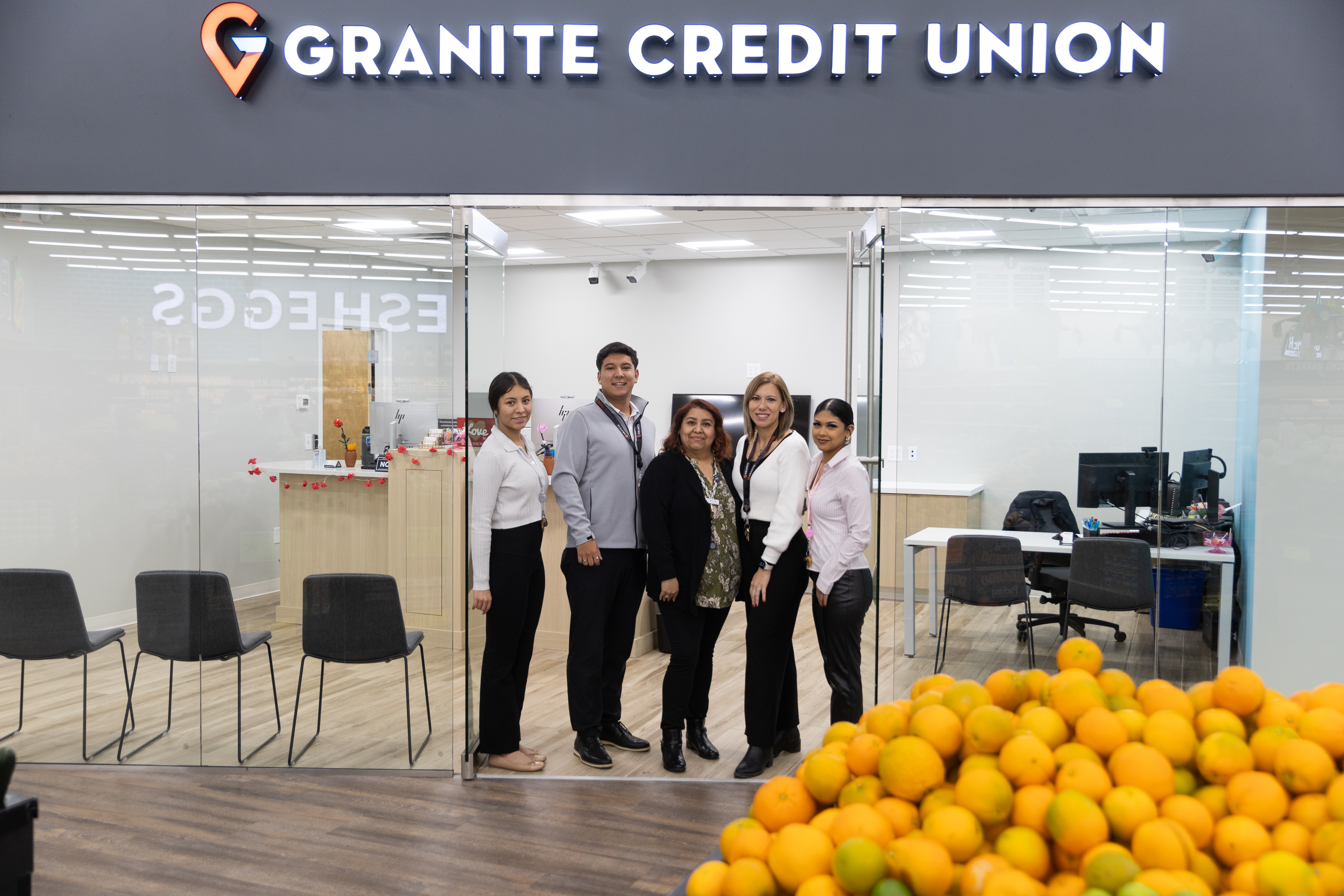 Granite Credit Union Opens New Branch Inside of Rancho Markets in Clearfield: Branch Manager, Ellie Hernandez and team pictured next to the 13th branch for Granite Credit Union