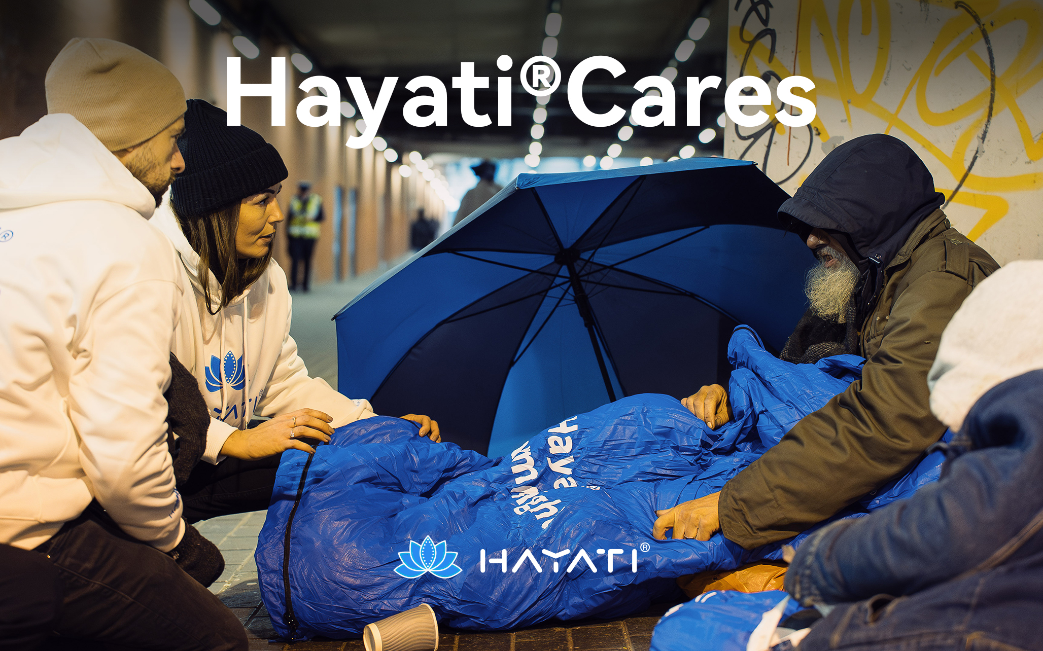 Hayati Cares Warm Night Project volunteers distributing blue sleeping bags to people experiencing homelessness