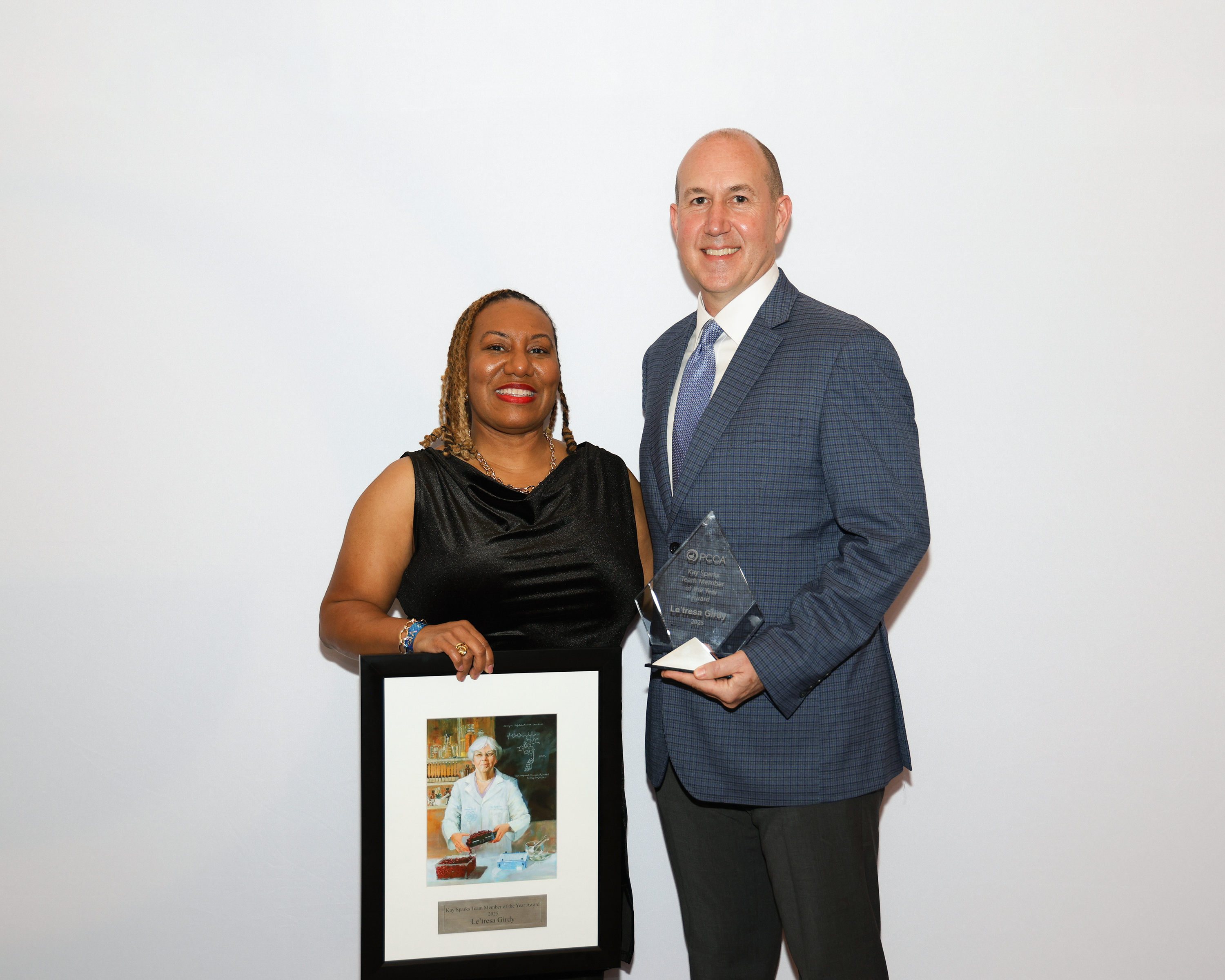 PCCA CEO Gus Bassani stands with PCCA USA Kay Sparks Team Member of the Year Le’tresa Girdy