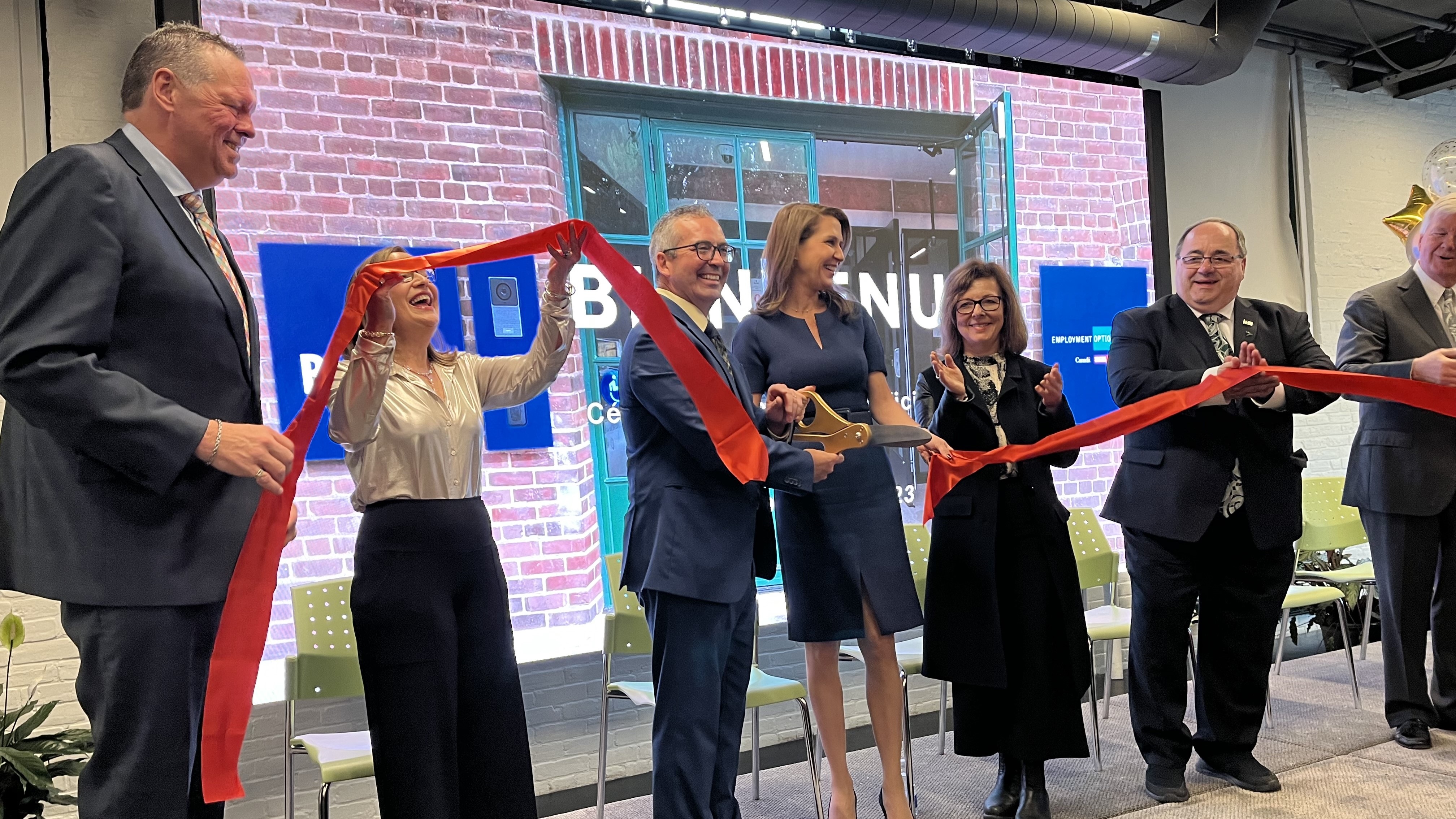 People celebrating during a ribbon-cutting ceremony at Collège Boréal’s new Toronto campus in the Distillery Historic District.