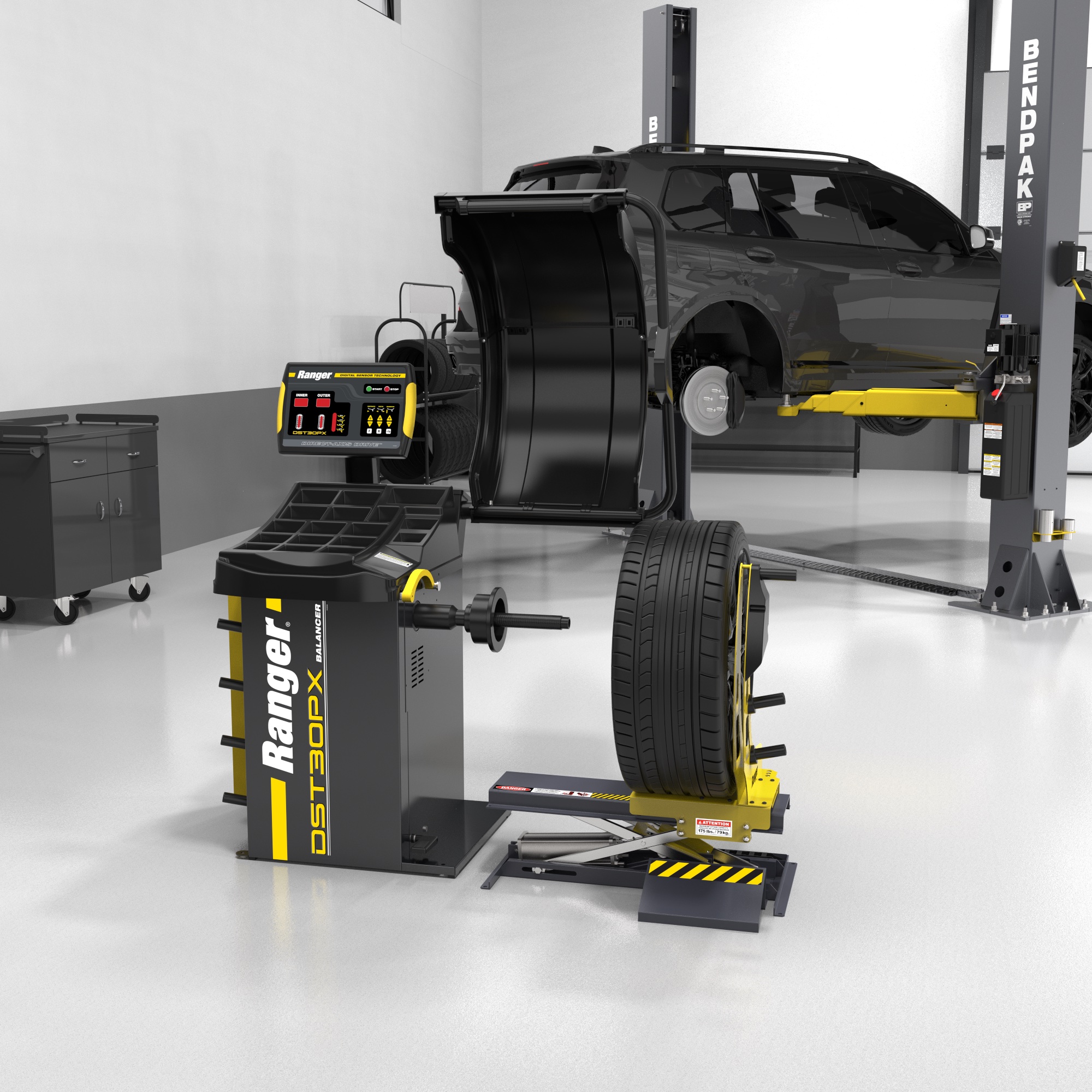 A Ranger RWL175 wheel lift holds a wheel in preparation for mounting on a Ranger wheel balancer in a professional shop 