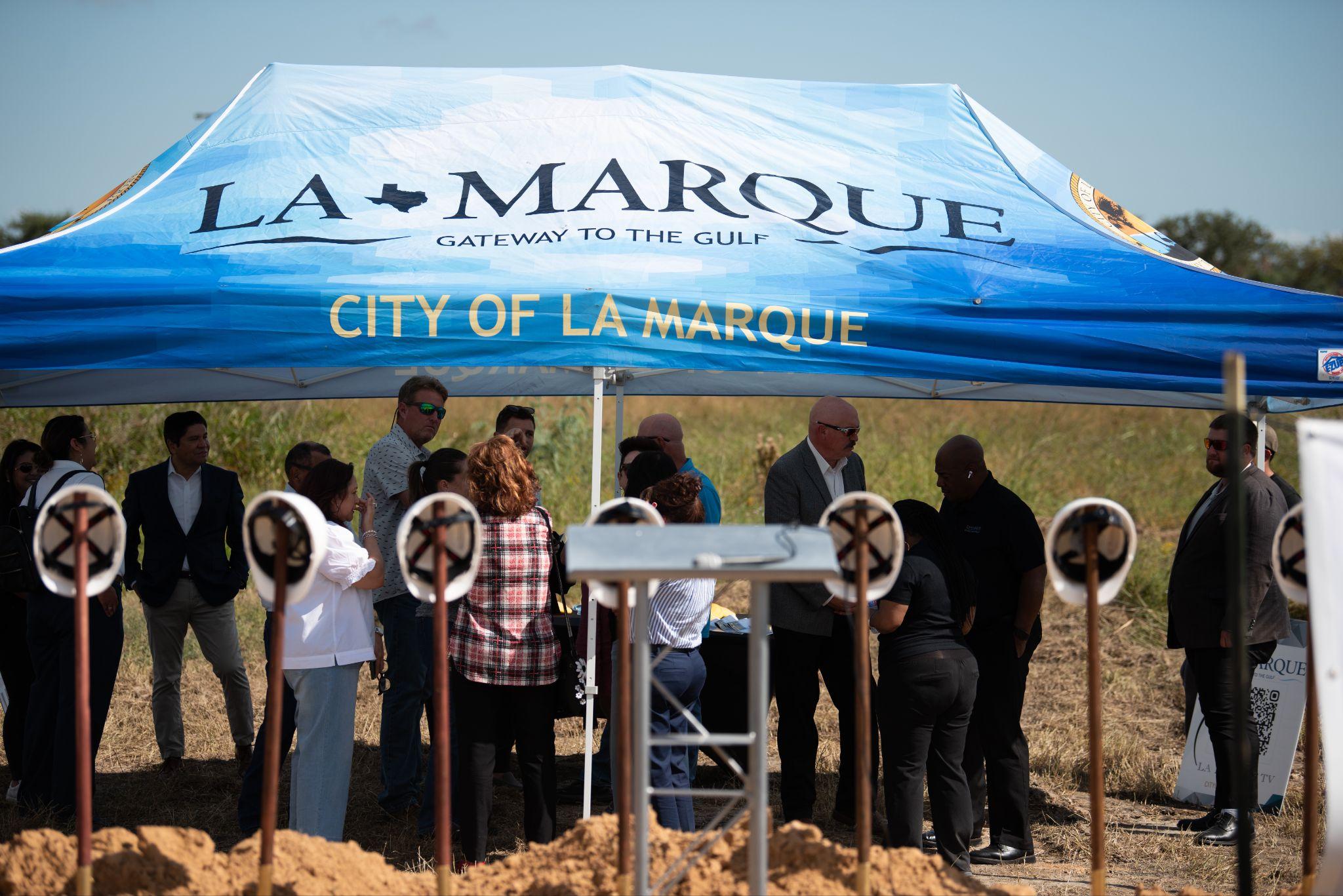 Attendees enjoy some shade before the ceremony and speeches begin.