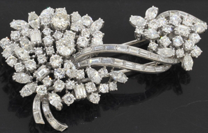 Heavy Platinum exquisite 18.70CTW VS diamond cluster floral ribbon brooch. Sold for $8,270
