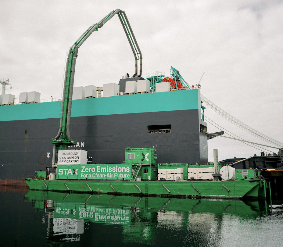 STAX Engineering and Seabound demonstrated the first-ever comprehensive emissions and carbon capture solution live from the Port of Long Beach. Pictured is the combined system atop a STAX barge servicing a Wallenius Wilhelmsen roll-on roll-off (RoRo) vessel, filtering out harmful pollutants including particulate matter and nitrogen oxide and capturing carbon dioxide directly from the vessel's exhaust.