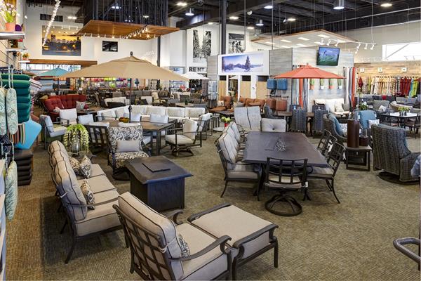 Image shows Christy Sports patio store showroom featuring many outdoor furniture sets