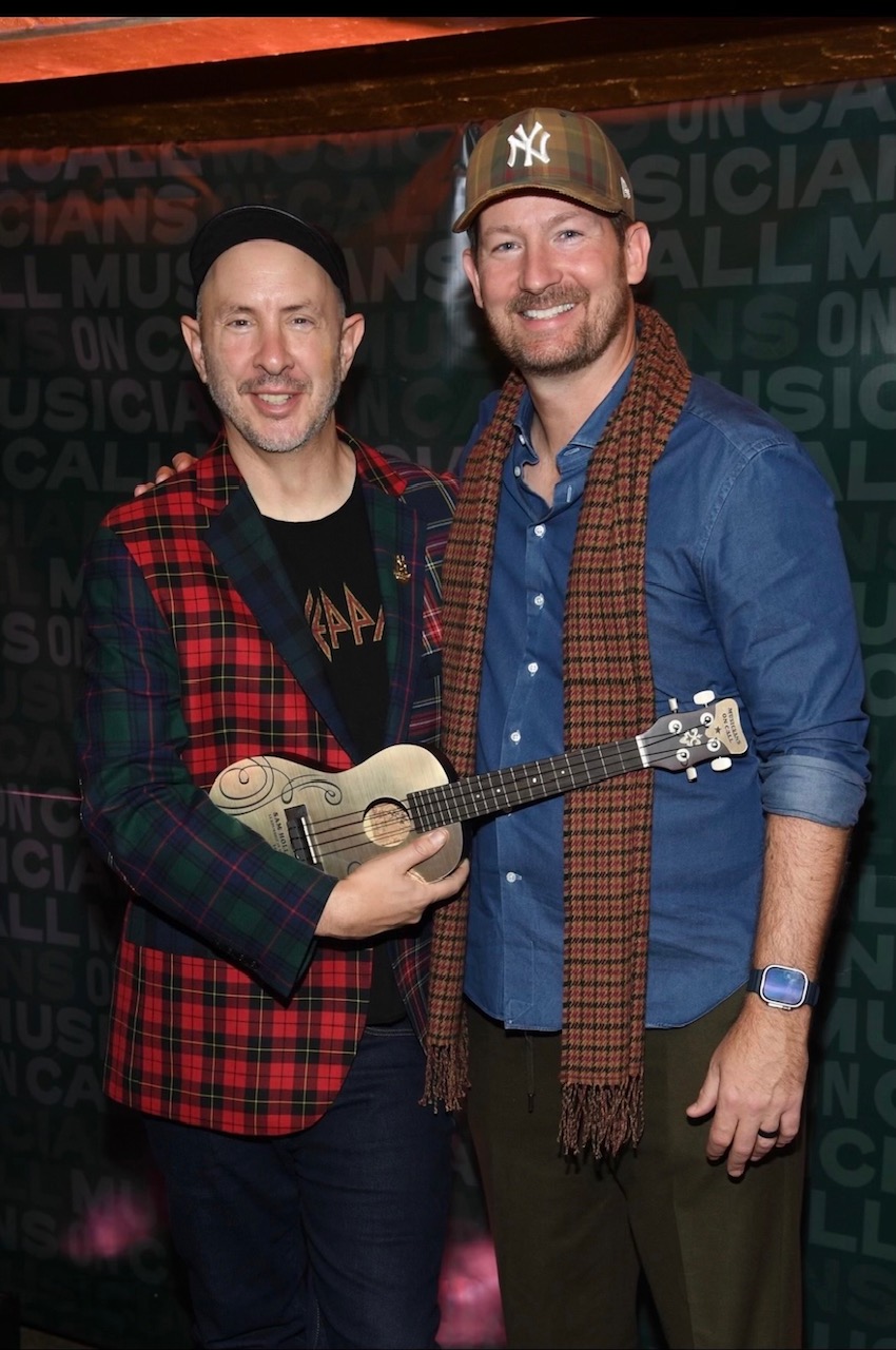 Sam Hollander receives the Leadership in Music Golden Ukulele from Pete Griffin at Musicians On Call's Hope for the Holidays concert for caregivers at Sony Hall in NYC