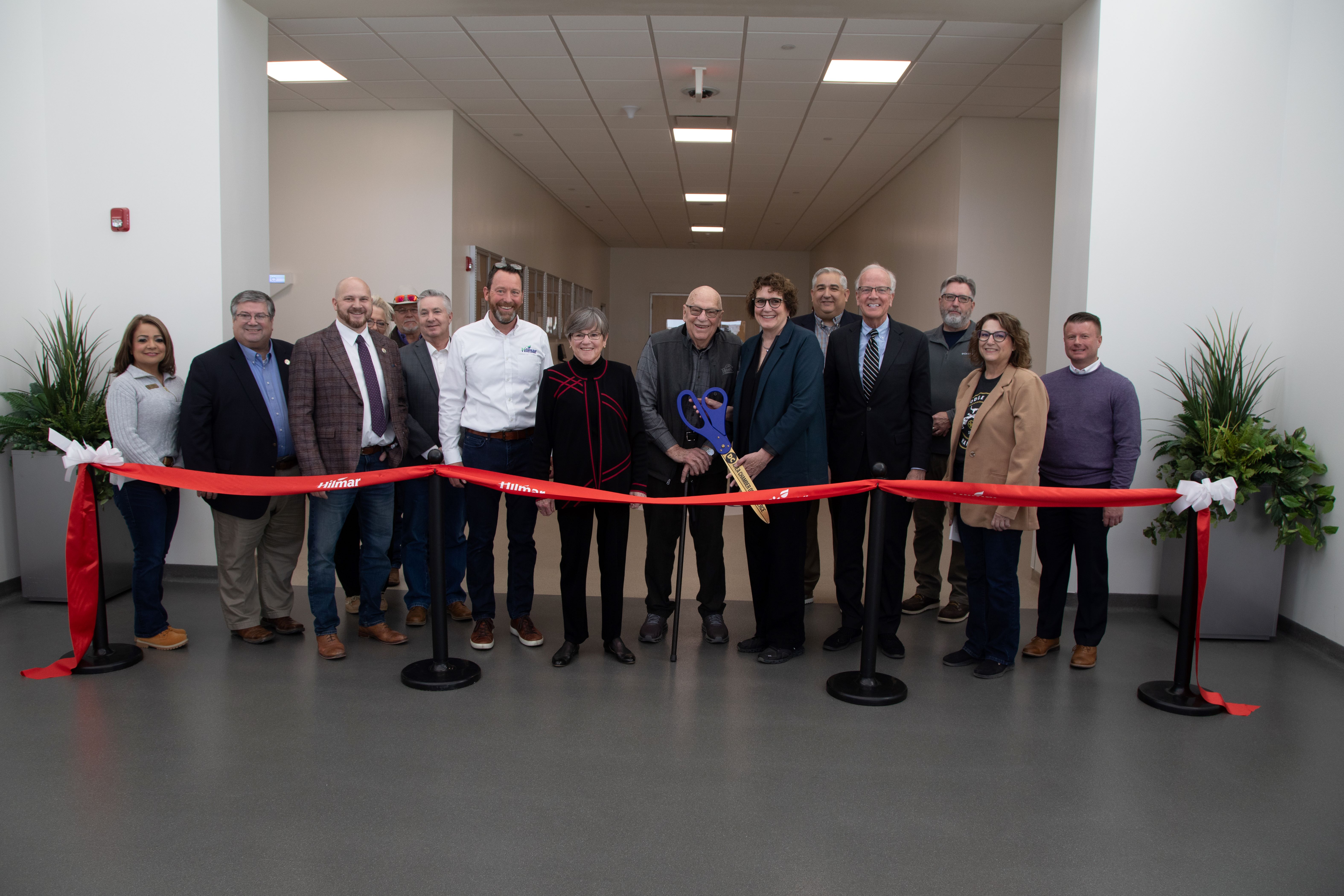 Kansas Governor Kelly, US Senator Moran and other federal, state and local officials with Hilmar leaders cut the ribbon.