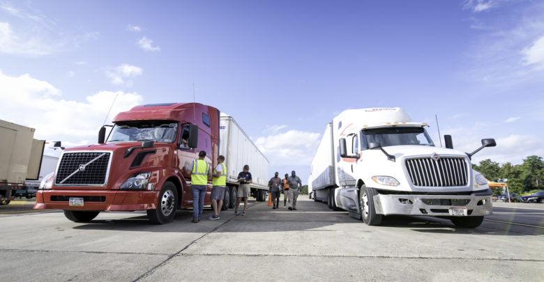 Anthony Jones, Ryan Sisson, and Derek Smith, center, Defense Logistics Agency Distribution Expeditionary team members, work with Federal Emergency Management Agency employees, left, at FEMA Incident Staging Base, Maxwell Air Force Base, Montgomery, Alabama, Sept. 2 to stage trucks arriving with commercial meals in preparation for Hurricane Dorian support efforts.  Photo by Jim Allen
