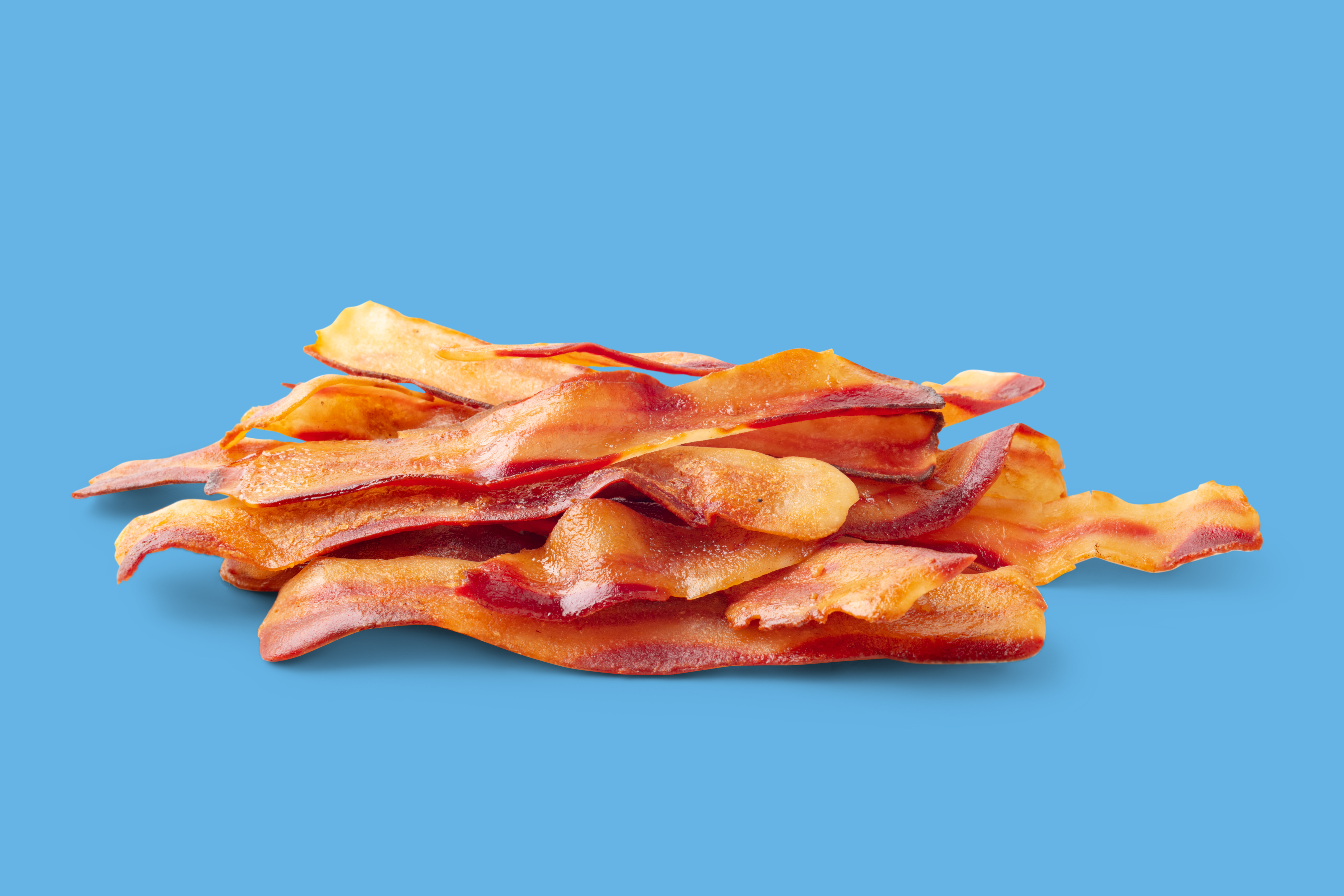 Pile of Bacon Blue Background_credit Hooray Foods