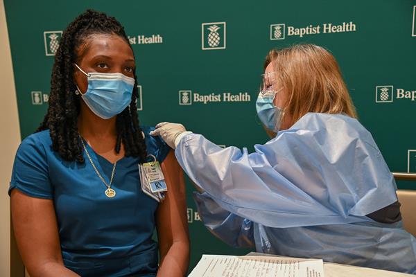 Daphne Pierre, ICU Nurse at South Miami Hospital, receives first COVID-19 vaccine at Baptist Health