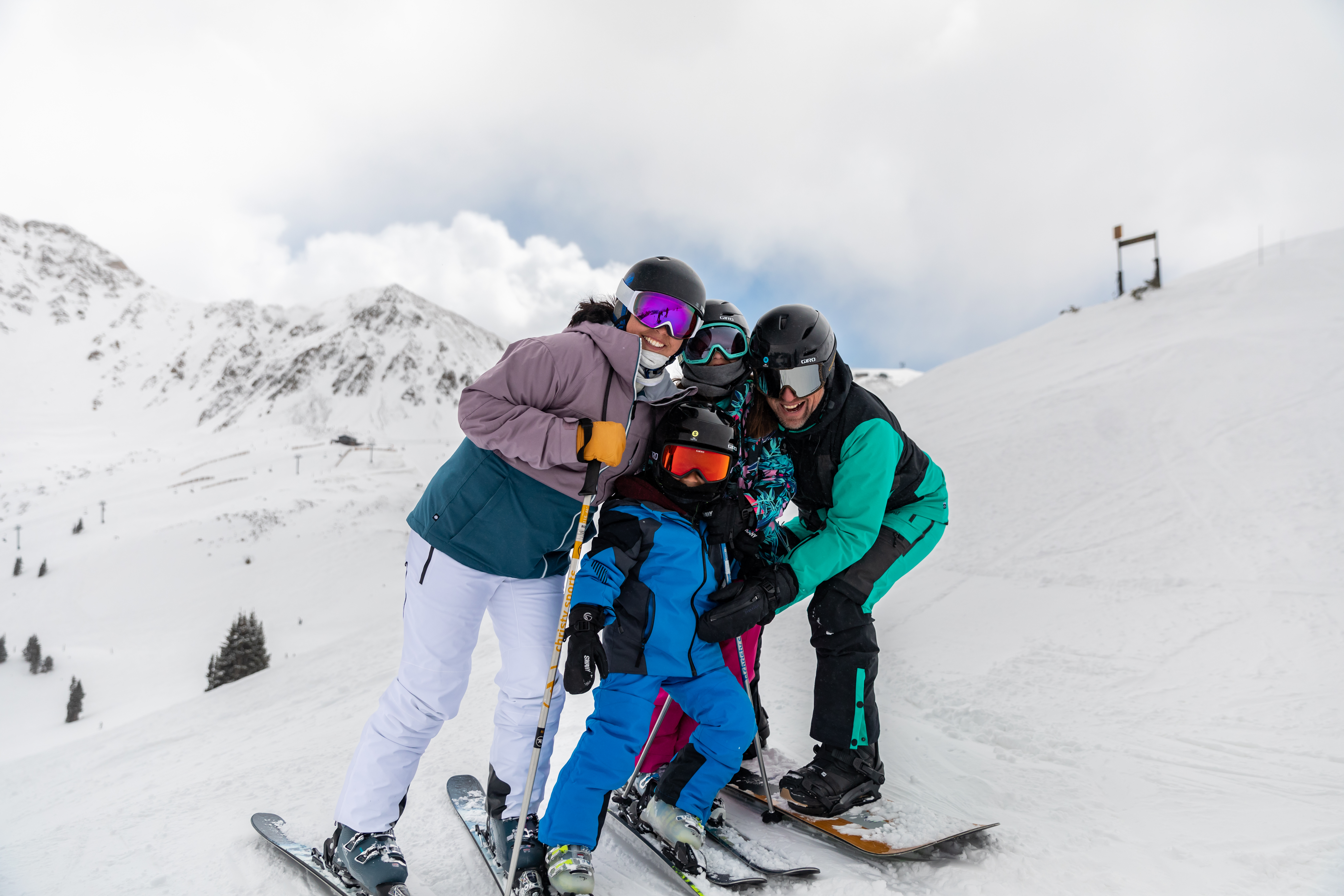 Image shows a family of four on the ski slopes, enjoying a spontaneous day on the mountain with same-day rentals from Christy Sports.