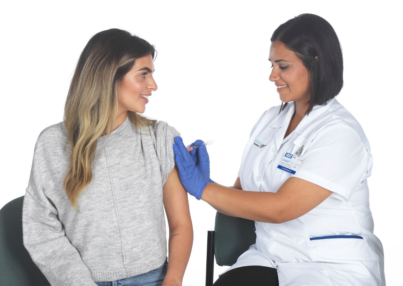 London Drugs pharmacist,  Vaneet Chahal, administers a flu shot.