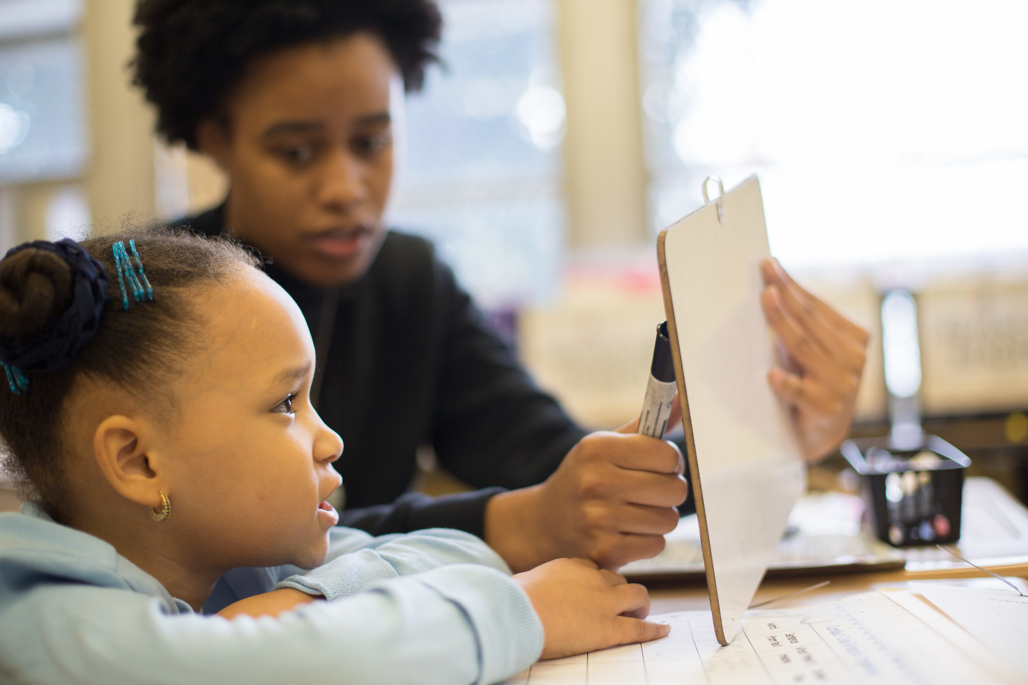 Photo of a student and volunteer tutor in a Reading Partners reading center (Photo Credit: Reading Partners)